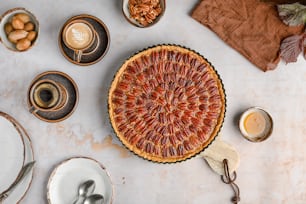 a pie sitting on top of a table next to plates