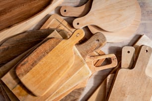 a group of wooden cutting boards and knives on a table