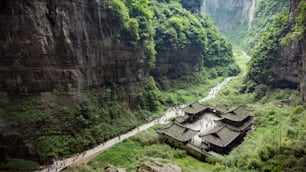 a group of people standing on a cliff above a valley