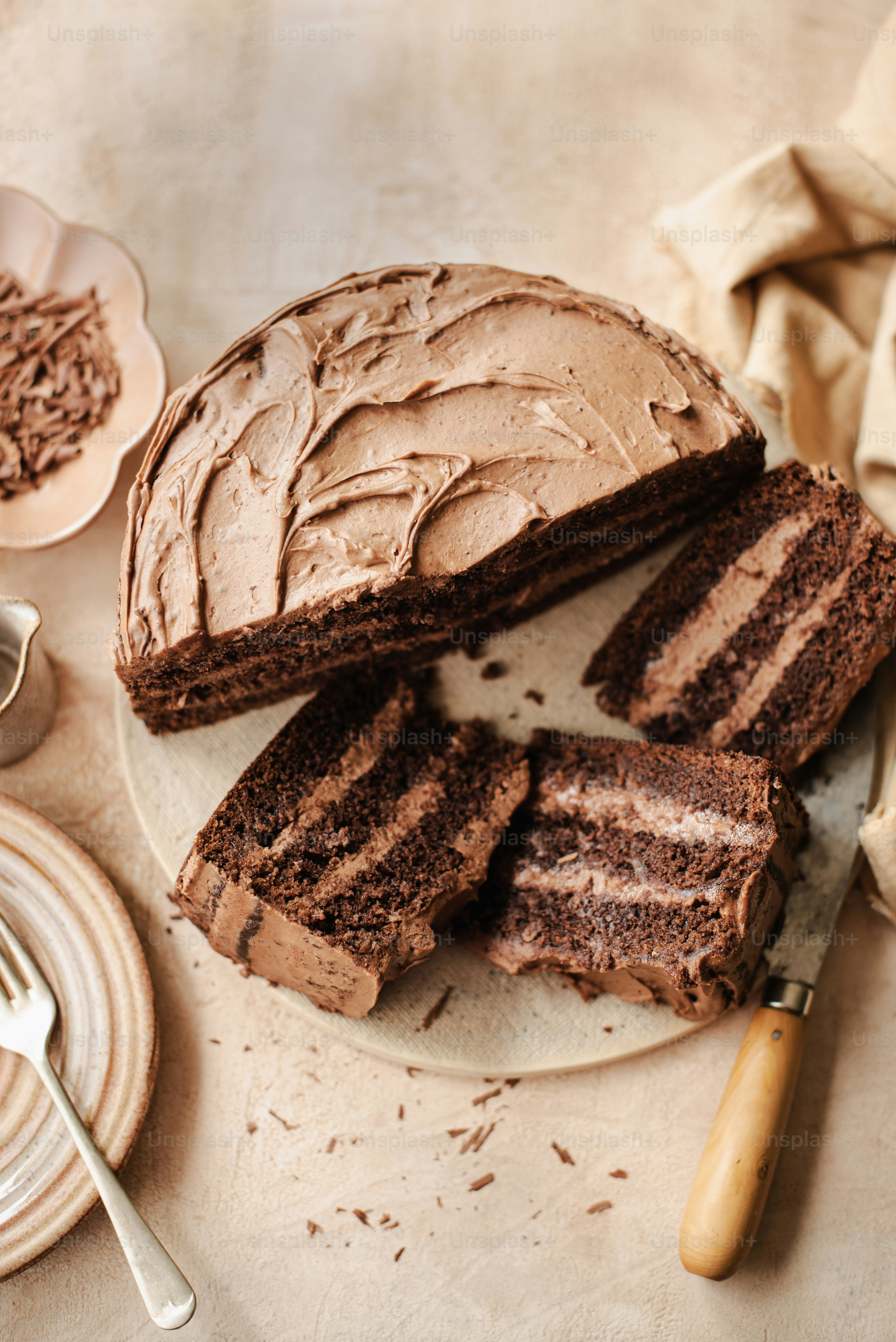 a chocolate cake on a plate with a slice cut out of it
