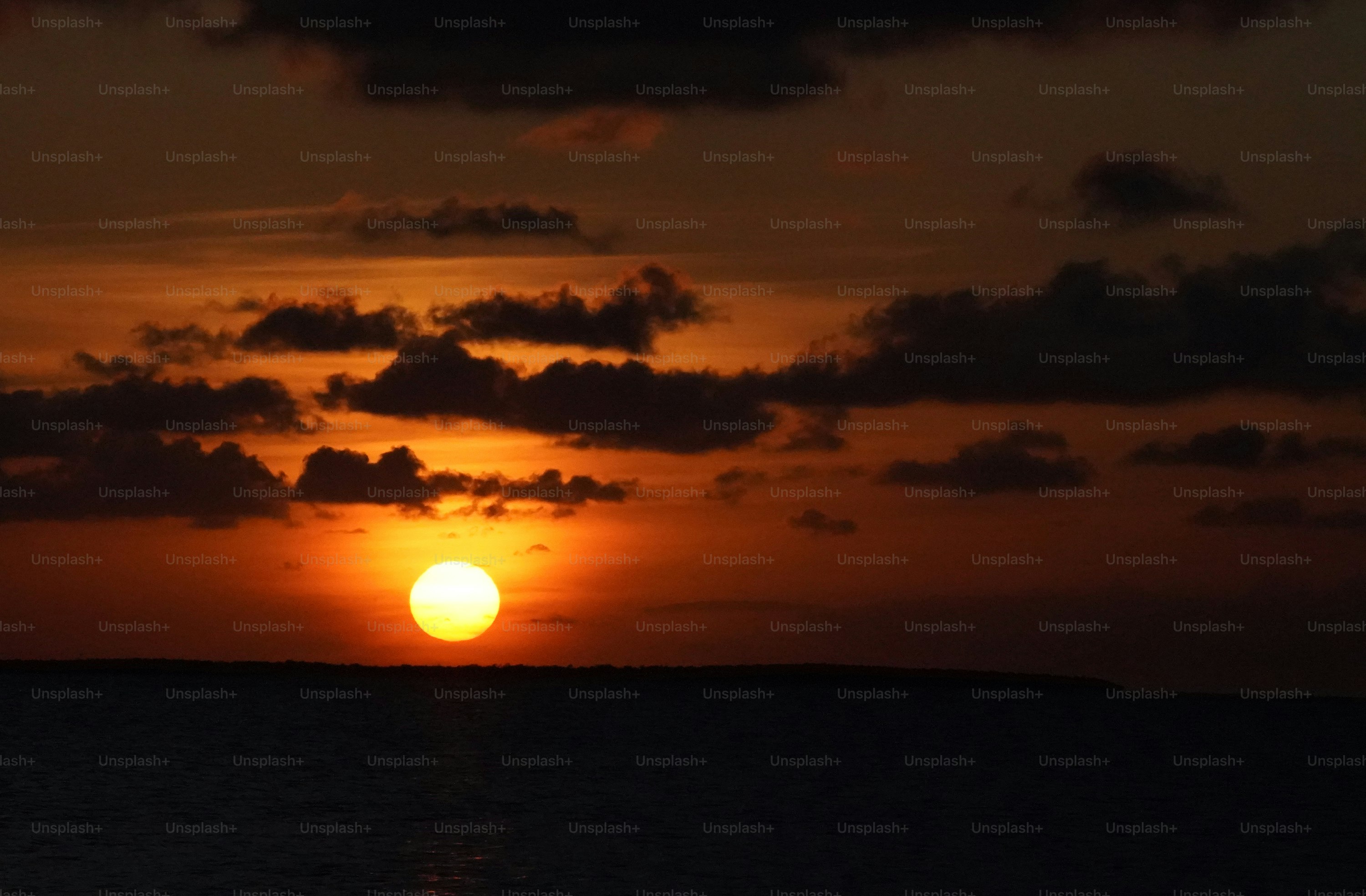 the sun is setting over a body of water