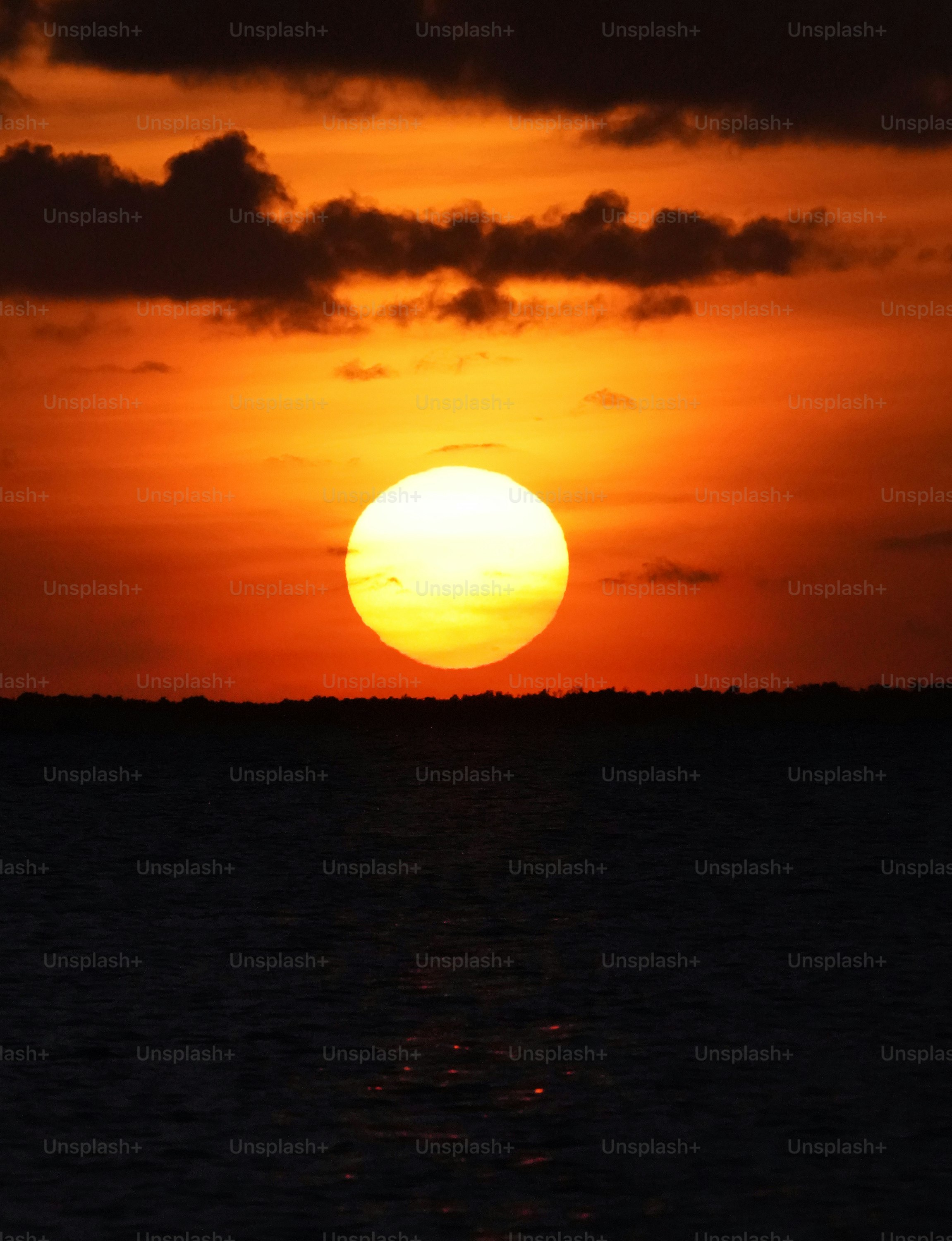 the sun is setting over a body of water