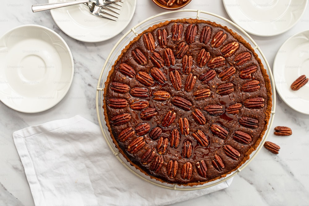 a pecan pie on a table with plates and forks