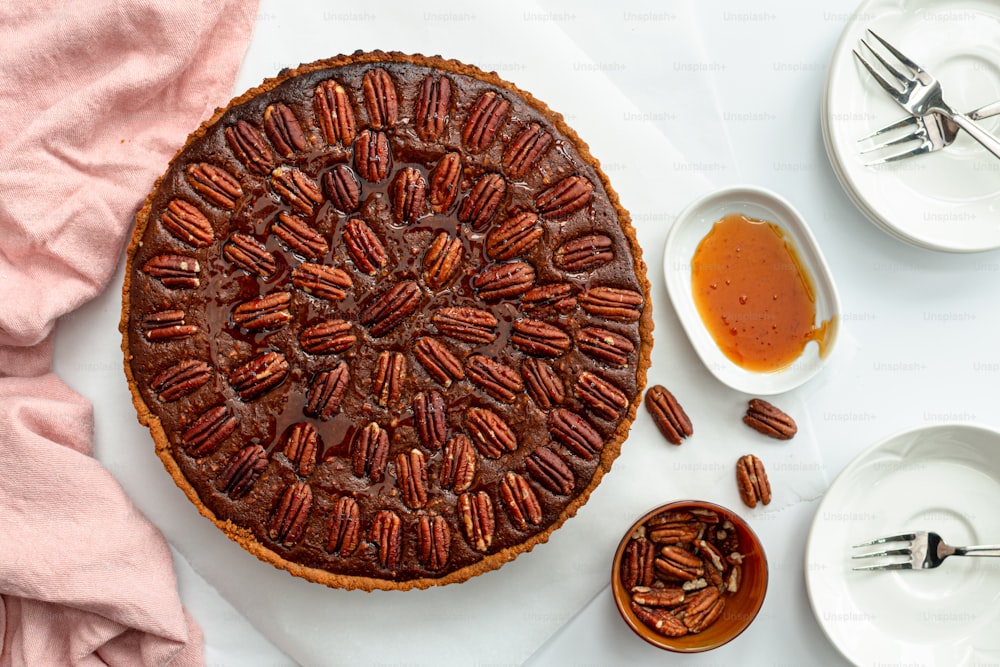 a pecan pie on a table with plates and utensils