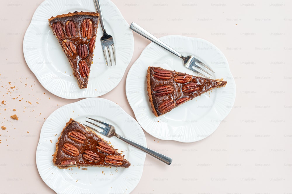 two plates with slices of pecan pie on them