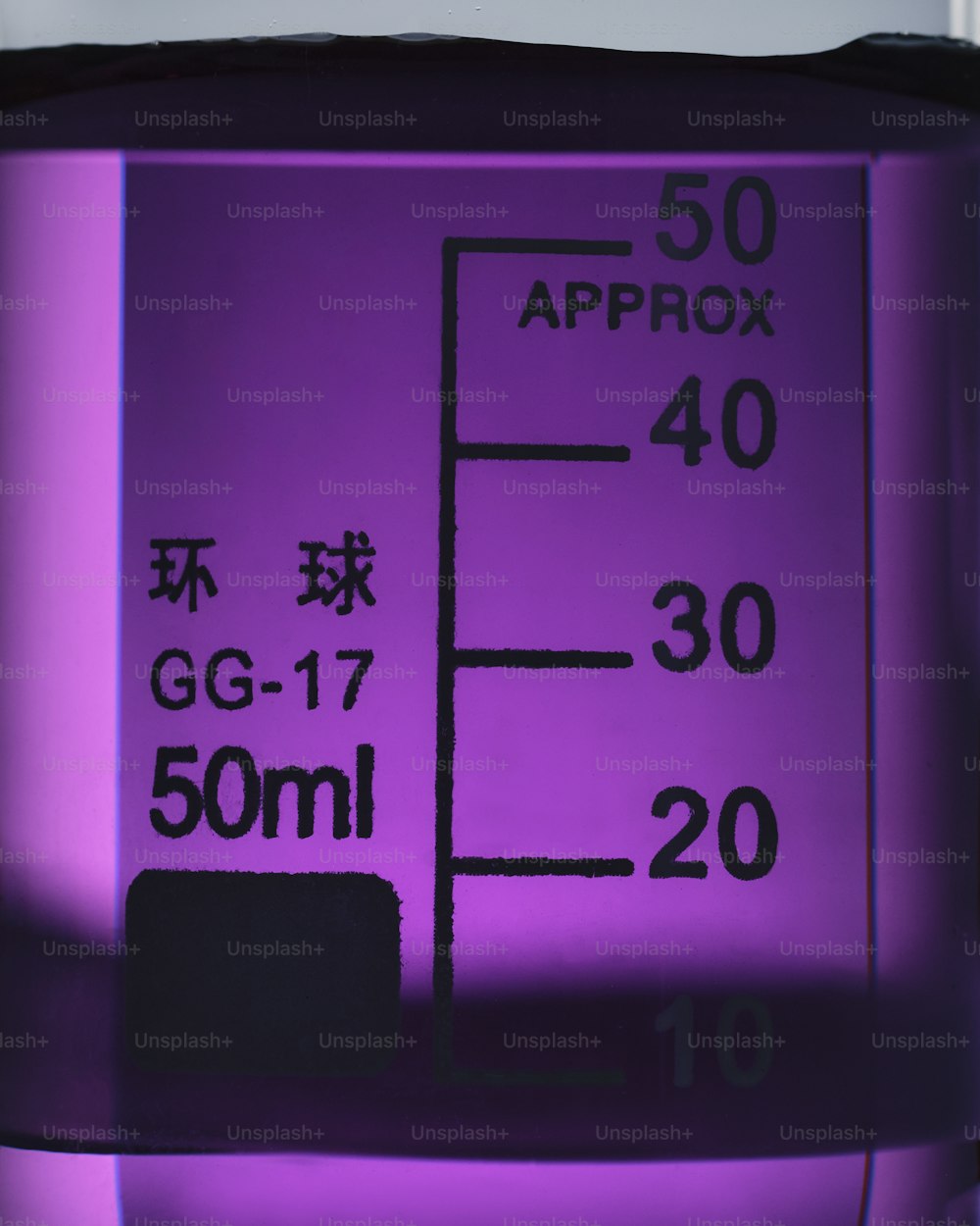 a close up of a purple substance with chinese writing on it