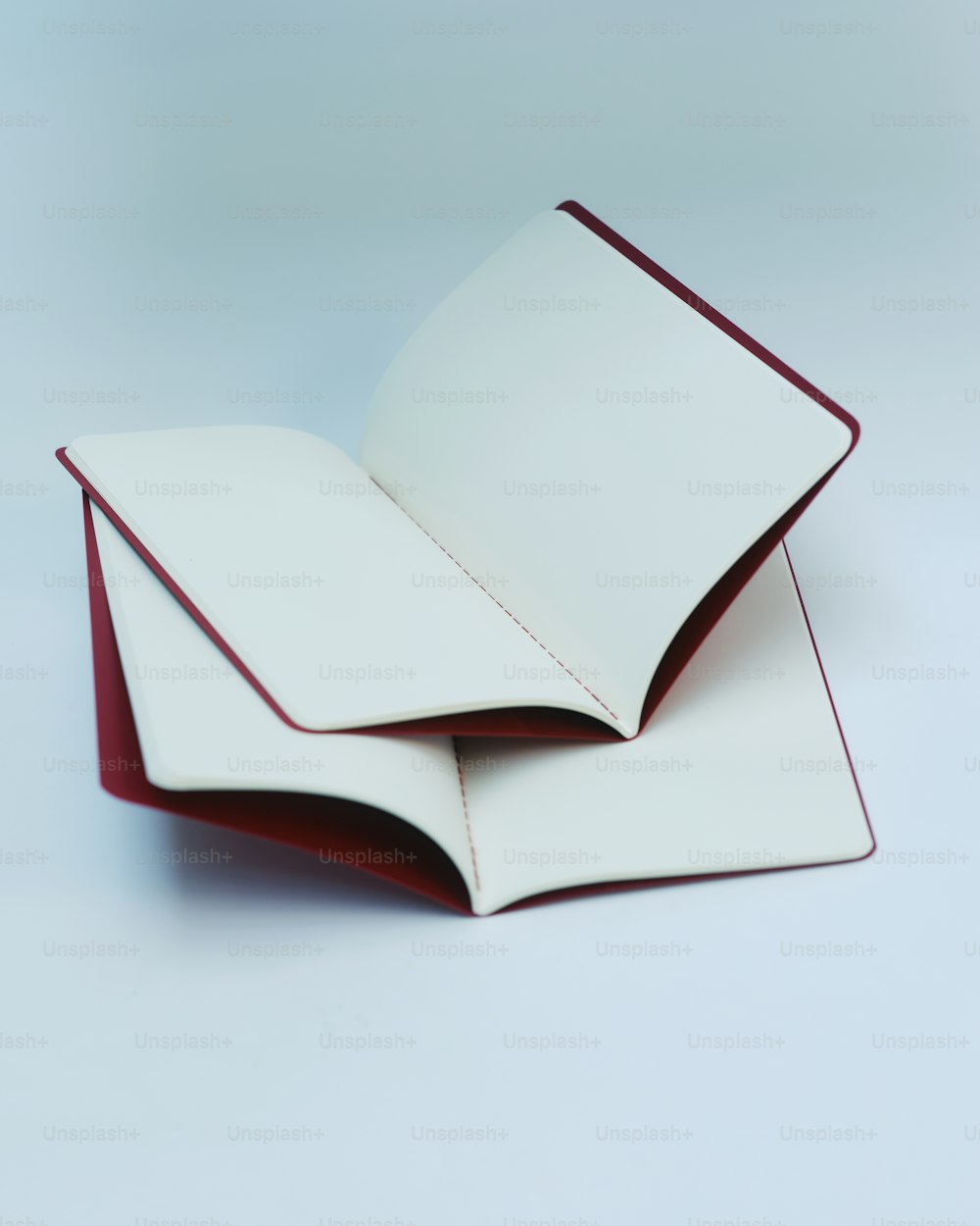 a stack of white and red papers on top of each other