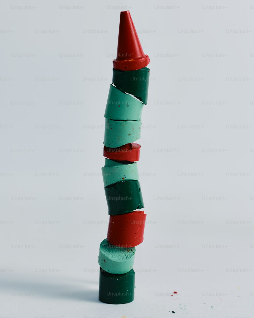 a stack of colored crayons sitting on top of each other