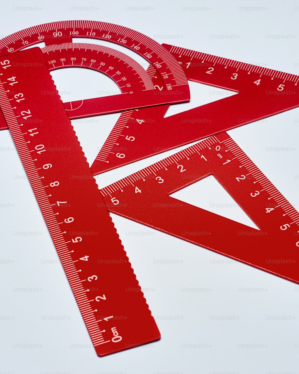 a pair of red rulers with a ruler on top of them