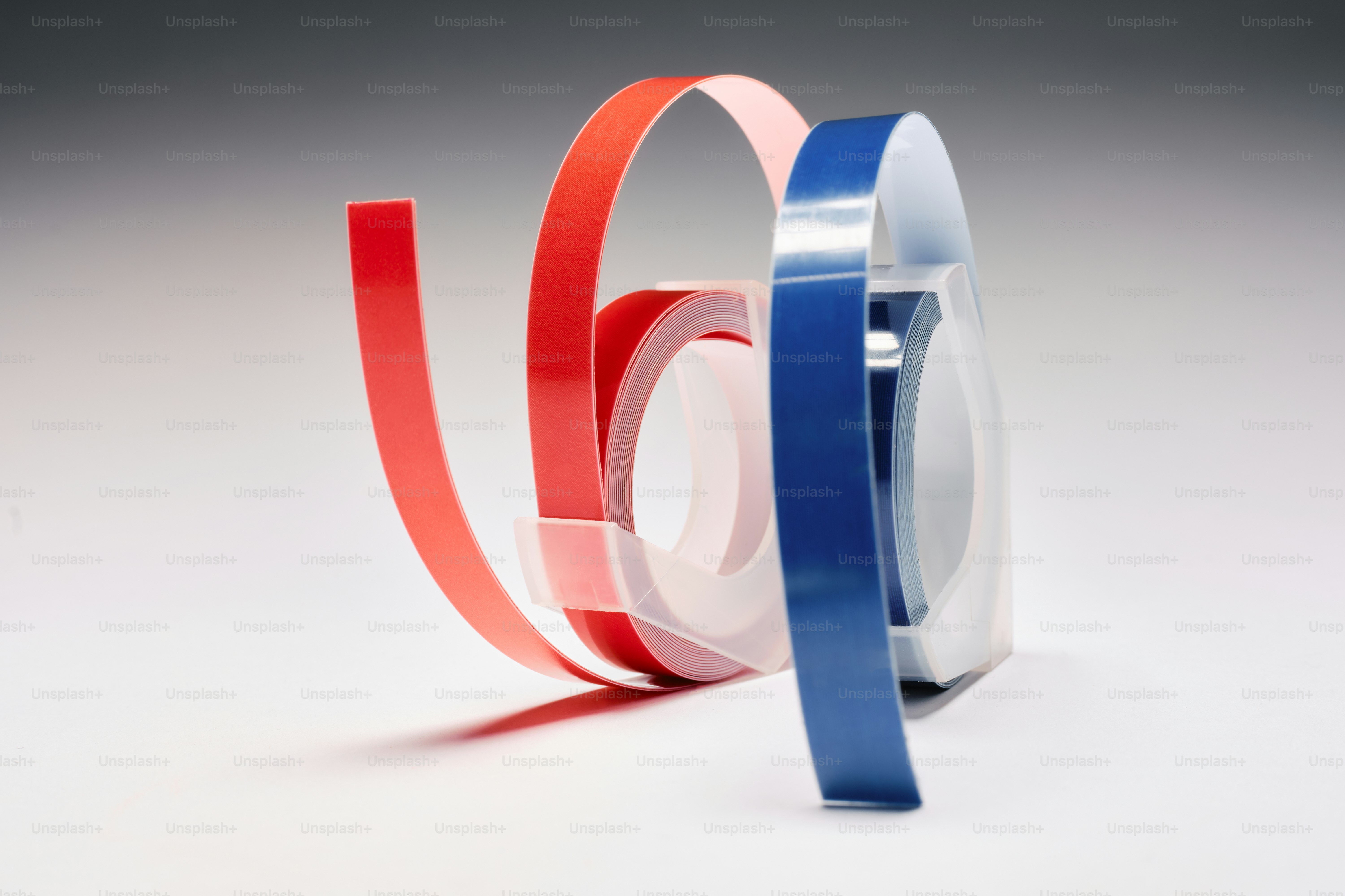 a couple of rolls of tape sitting on top of each other