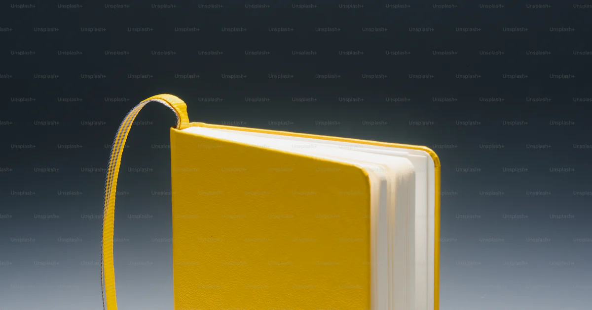 A yellow book with a yellow ribbon around it photo – School Image on ...
