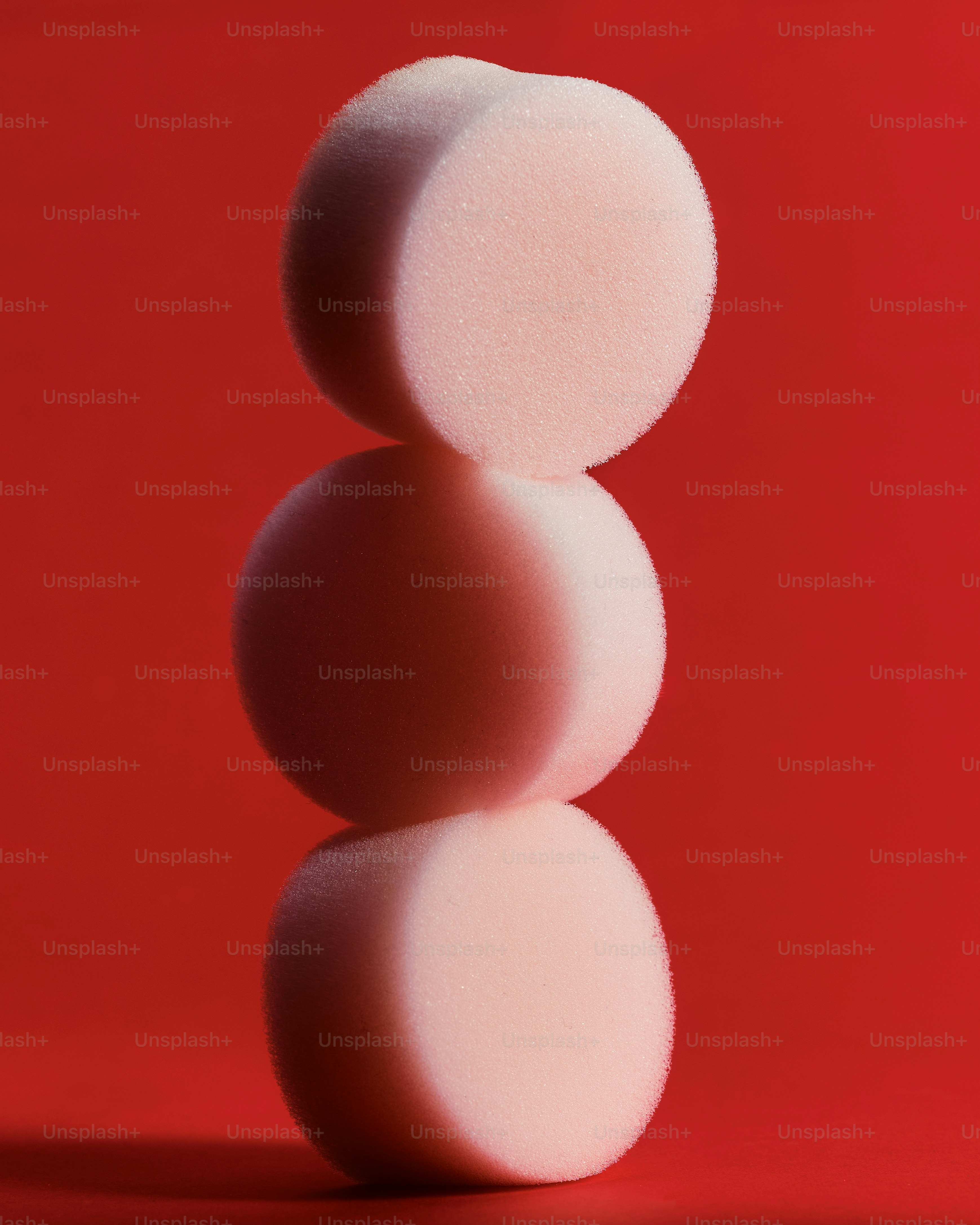 a pile of sponges sitting on top of a red surface