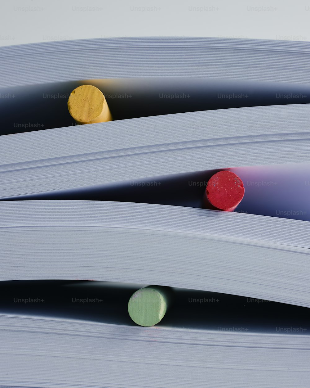 a close up of a stack of papers with markers