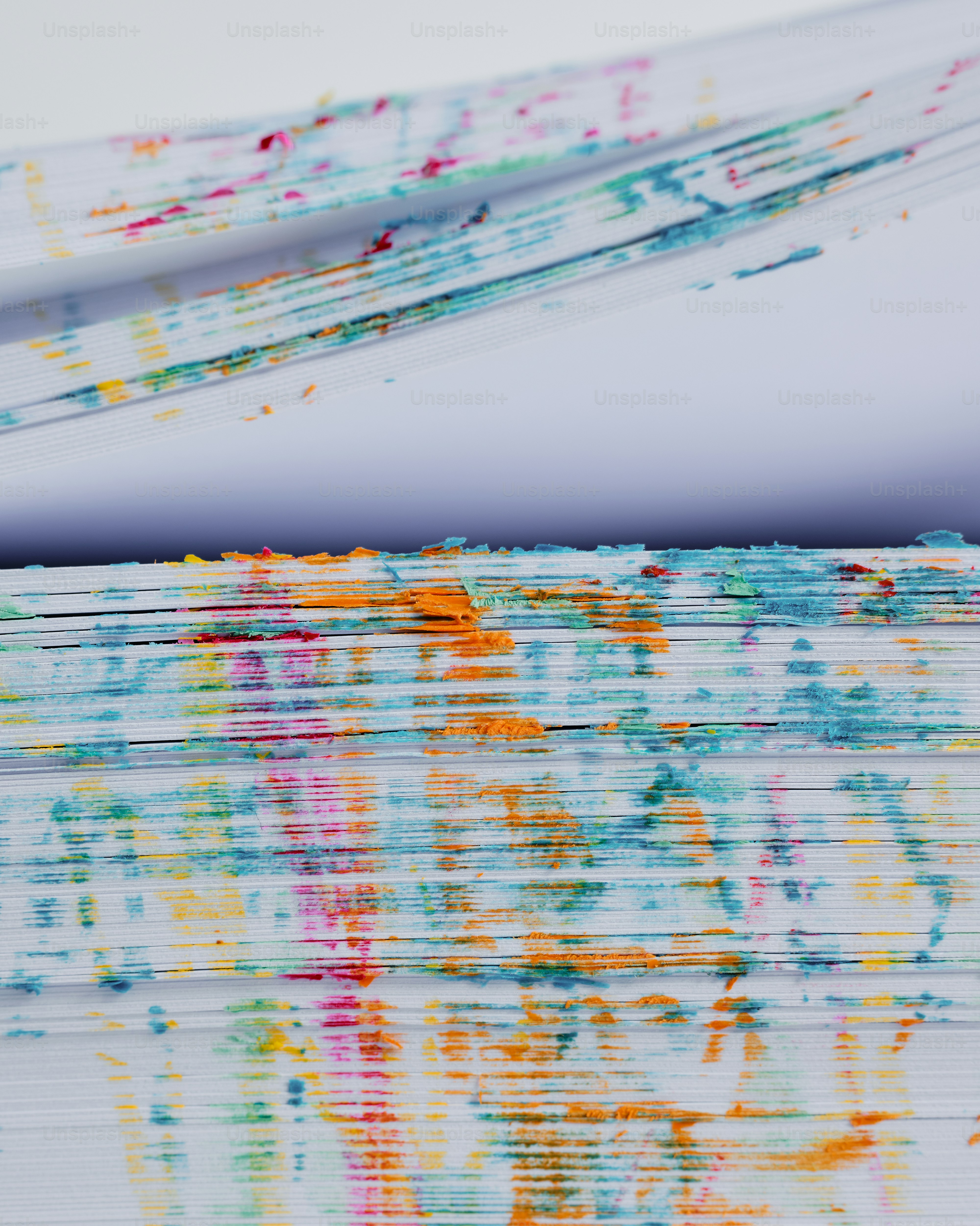 a close up of a piece of paper with paint splattered on it