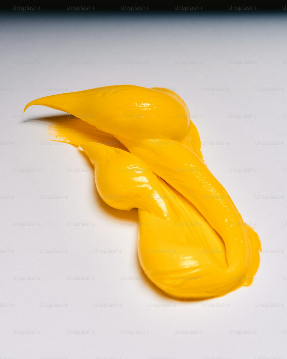 a close up of a yellow substance on a white surface