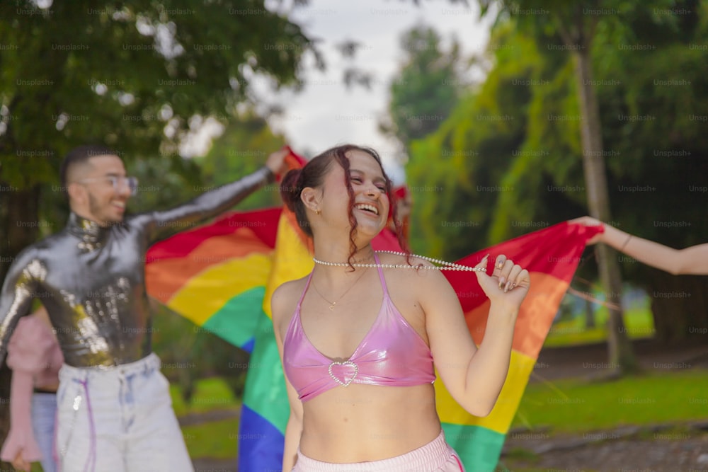 a woman in a bikini holding a rainbow flag