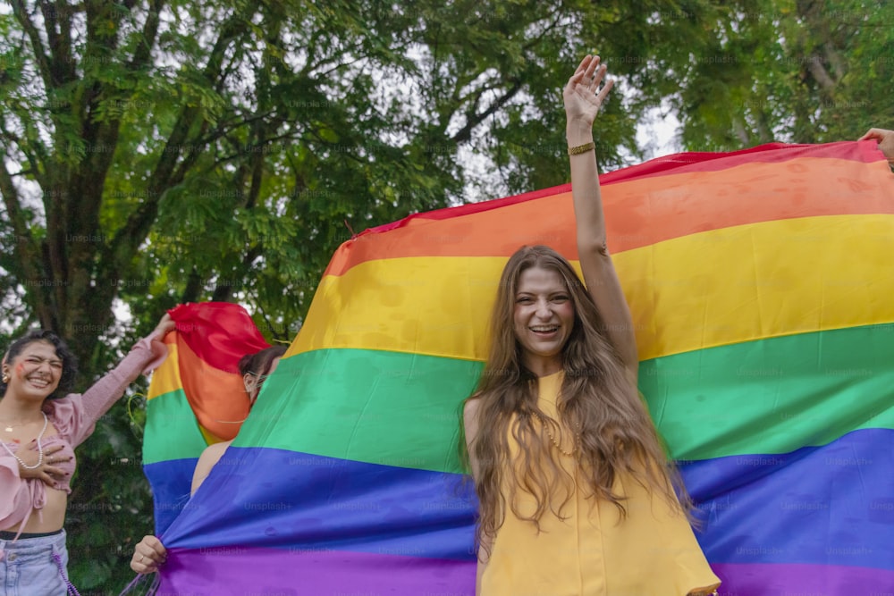 two women holding a rainbow flag and waving