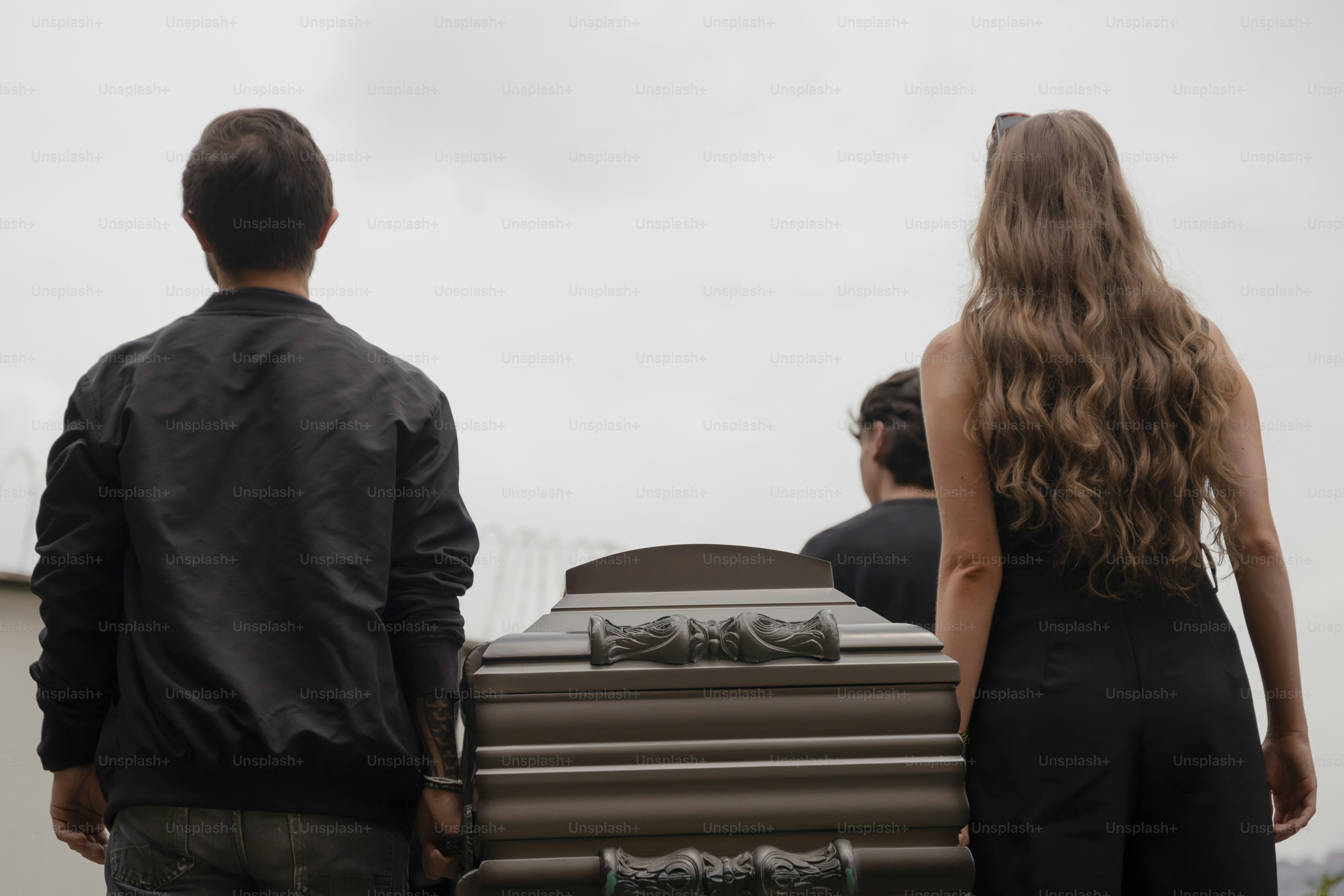a woman standing next to a man holding a suitcase