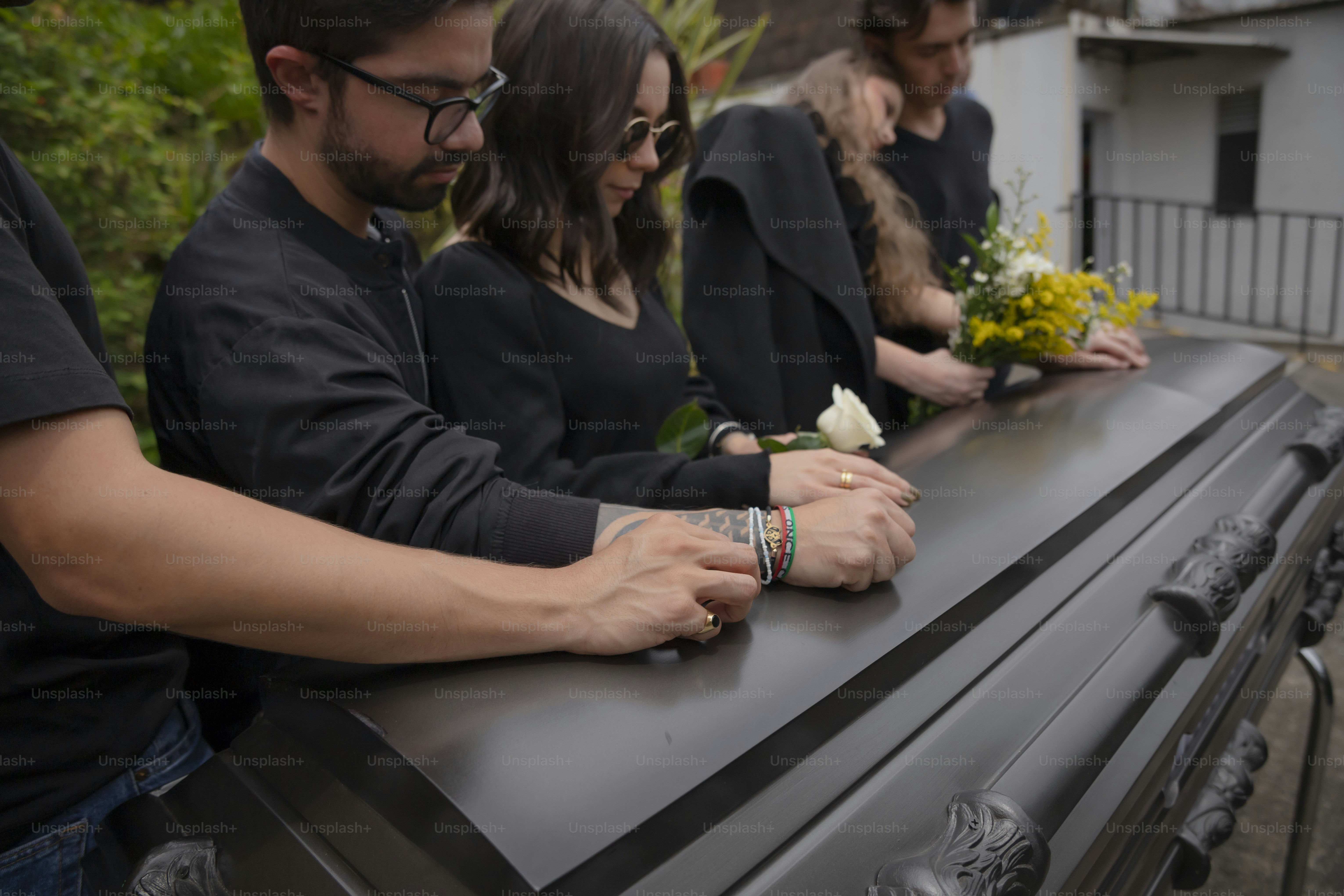 a group of people standing on top of a black table