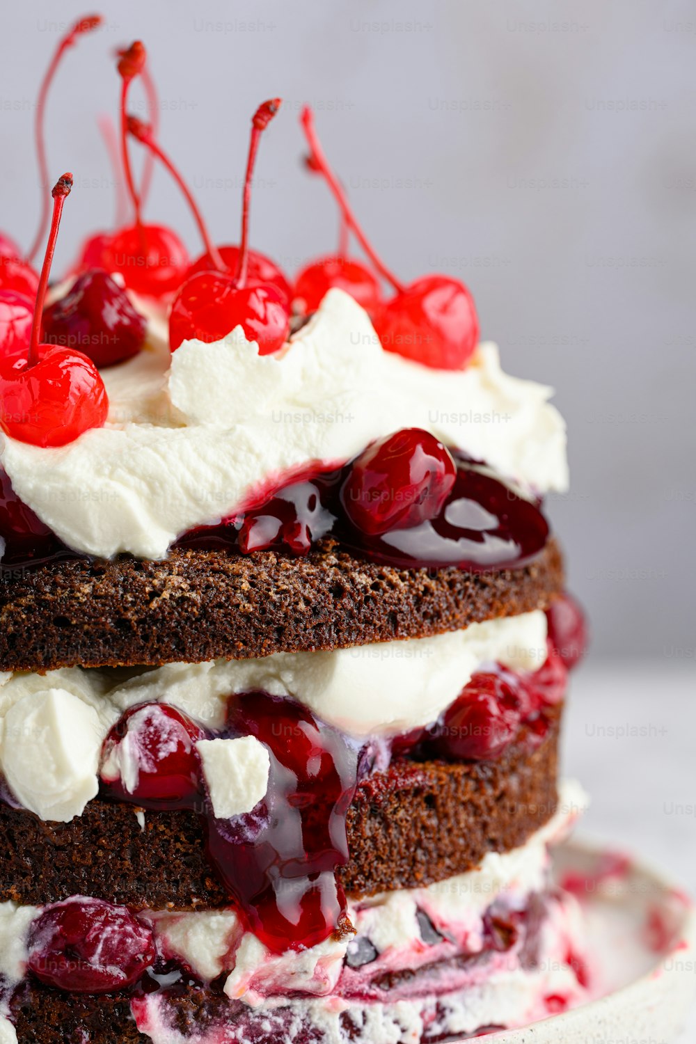 a close up of a cake with cherries on top