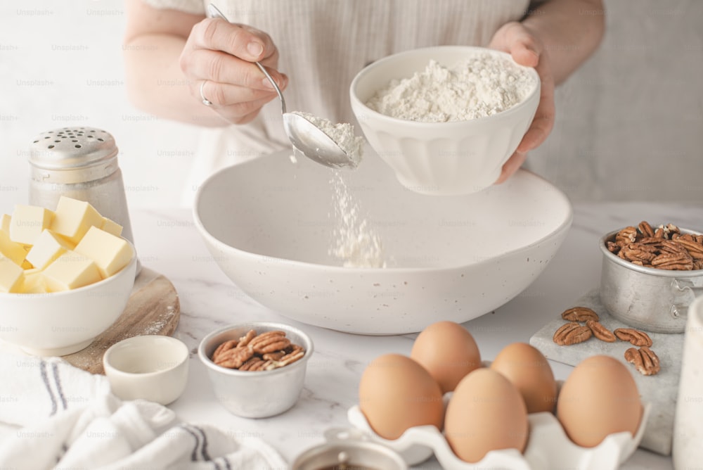 a person pouring milk into a bowl of food