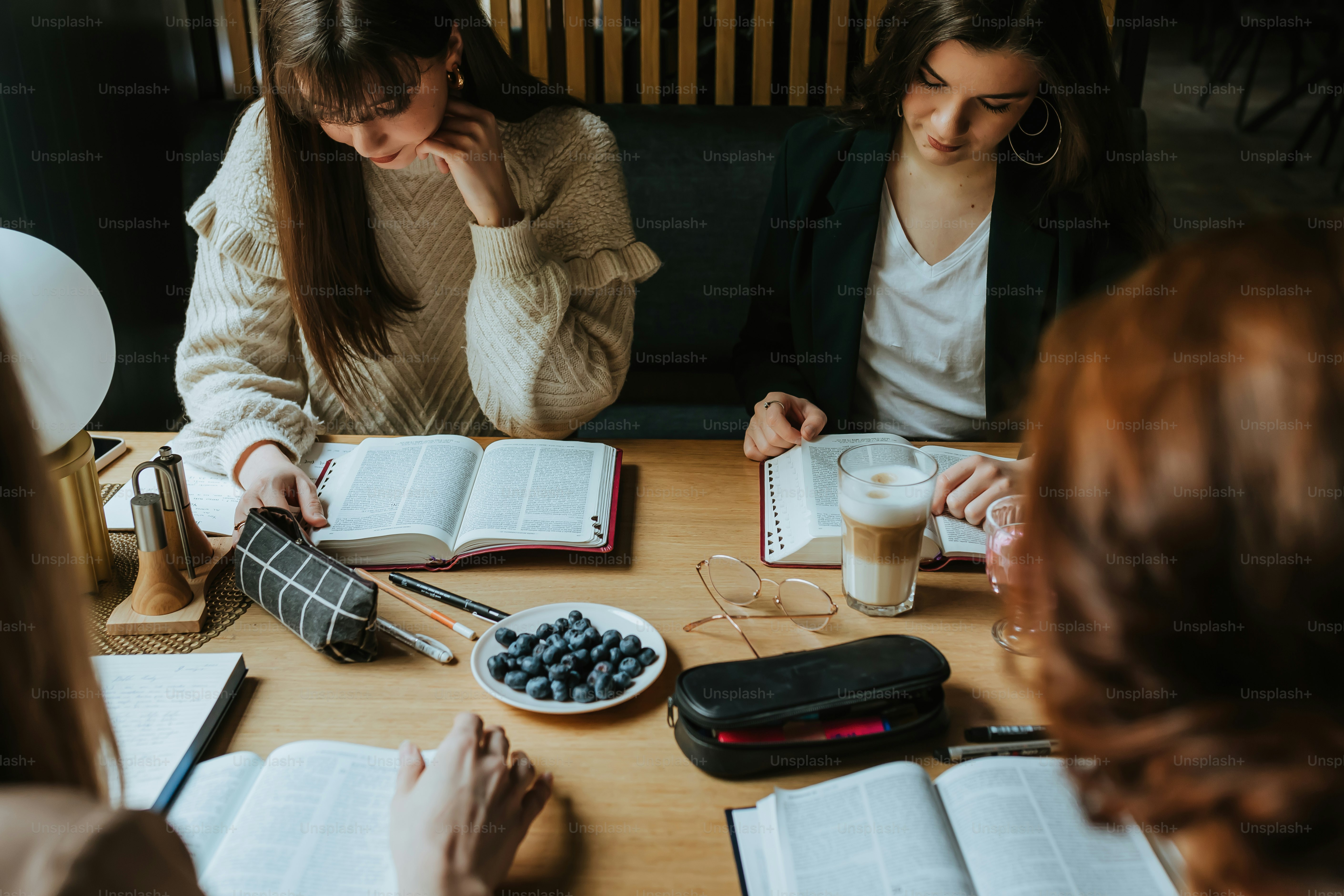 a group of women sitting around a wooden table