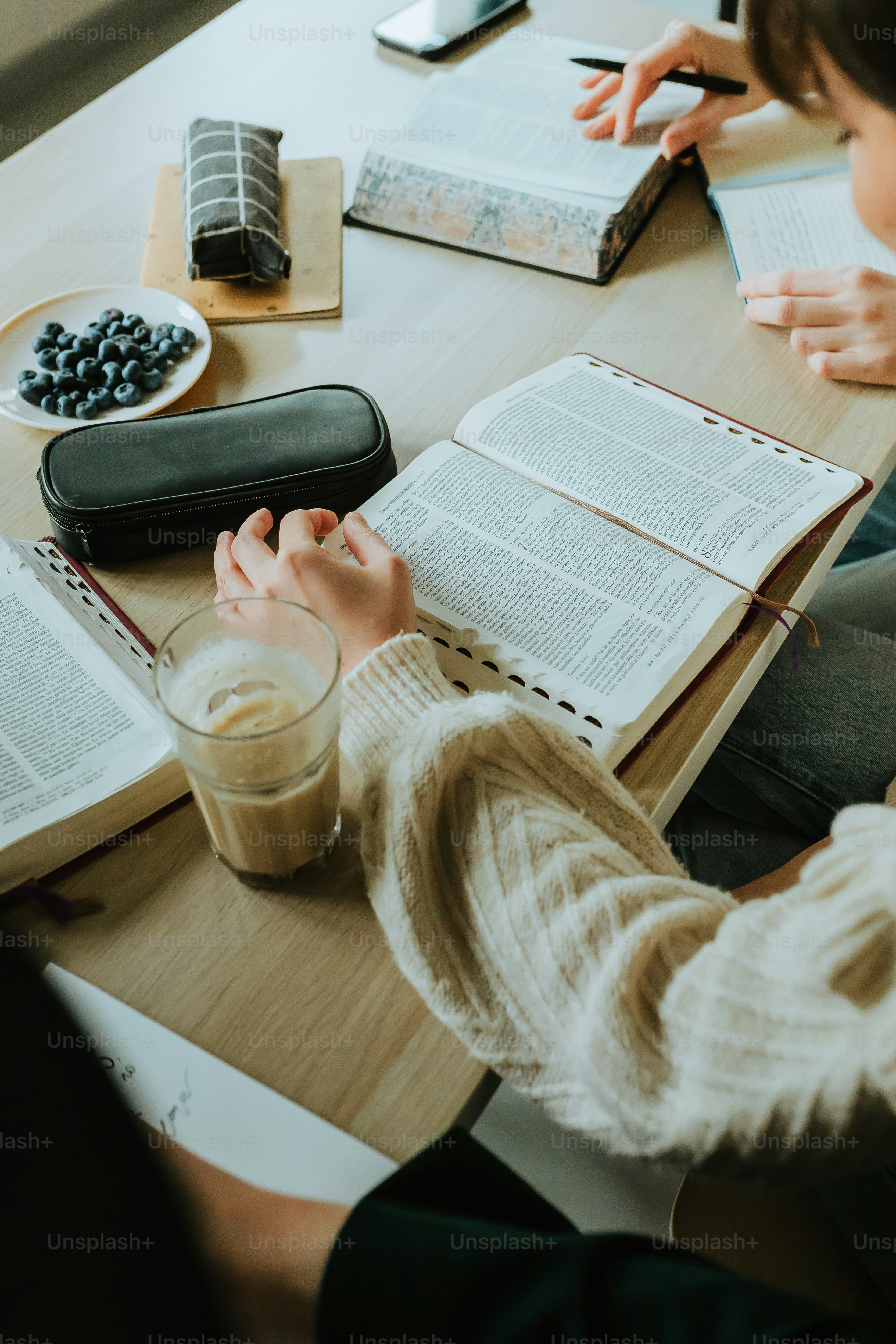 a person sitting at a table with an open book