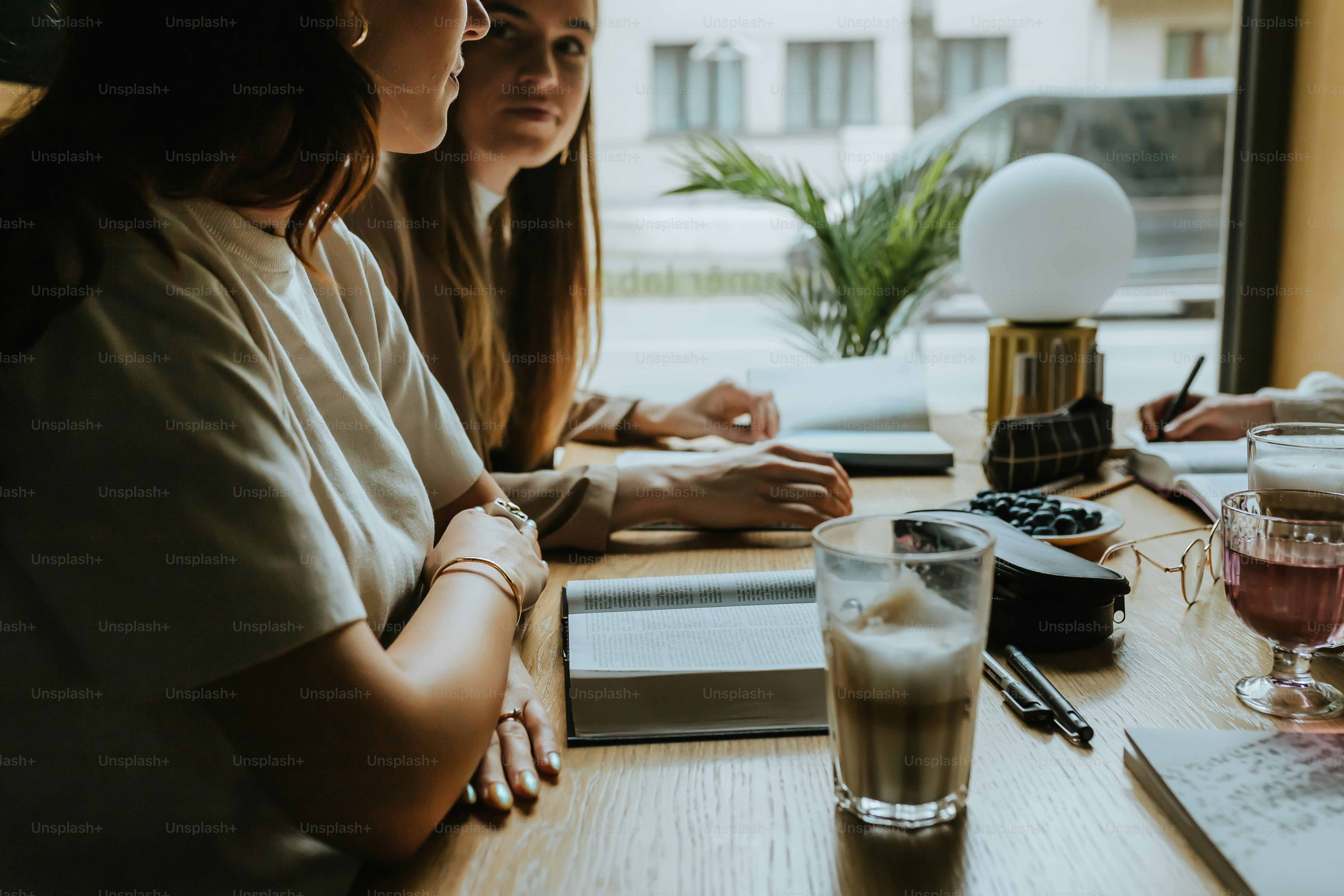 a group of people sitting around a wooden table