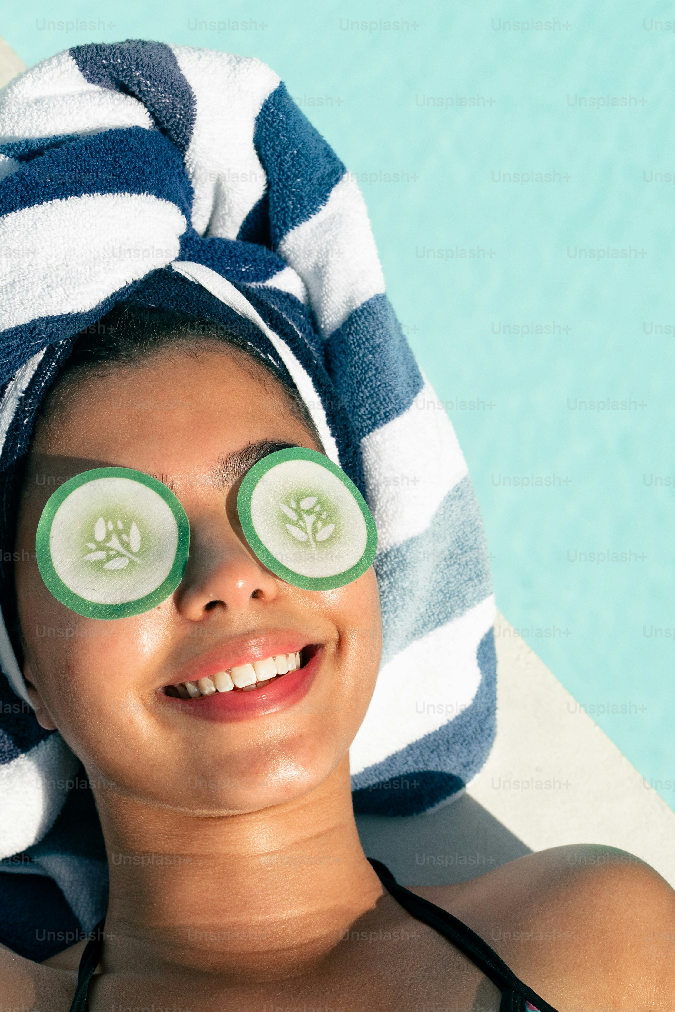 a woman with cucumber slices on her eyes