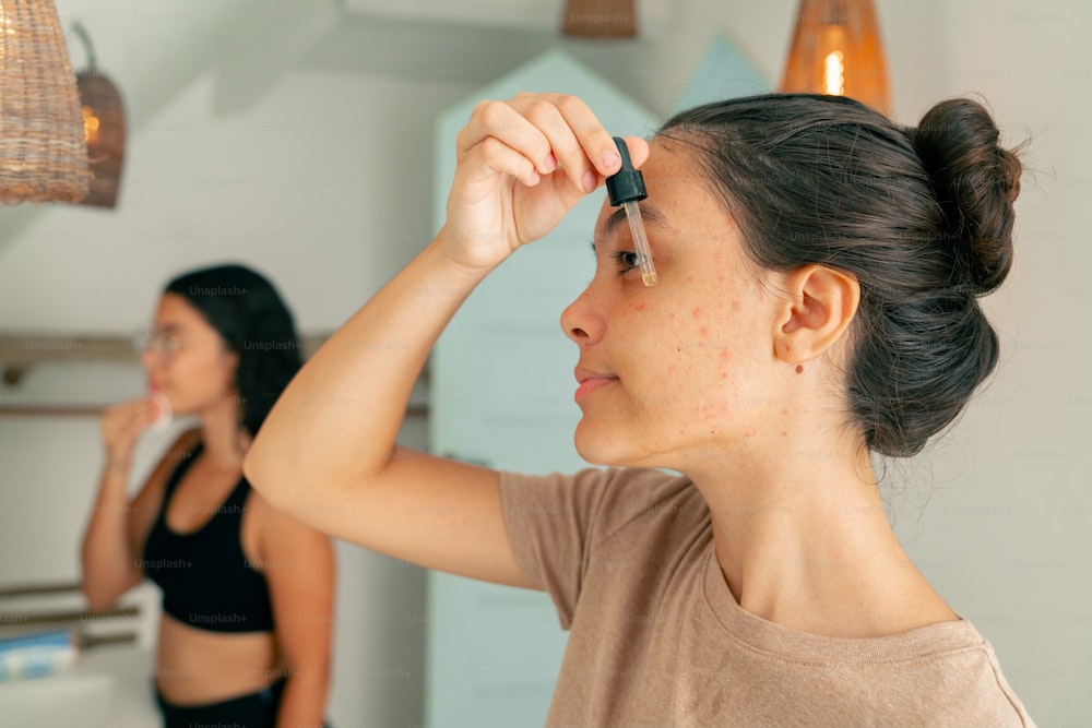 a woman is doing her hair in front of a mirror