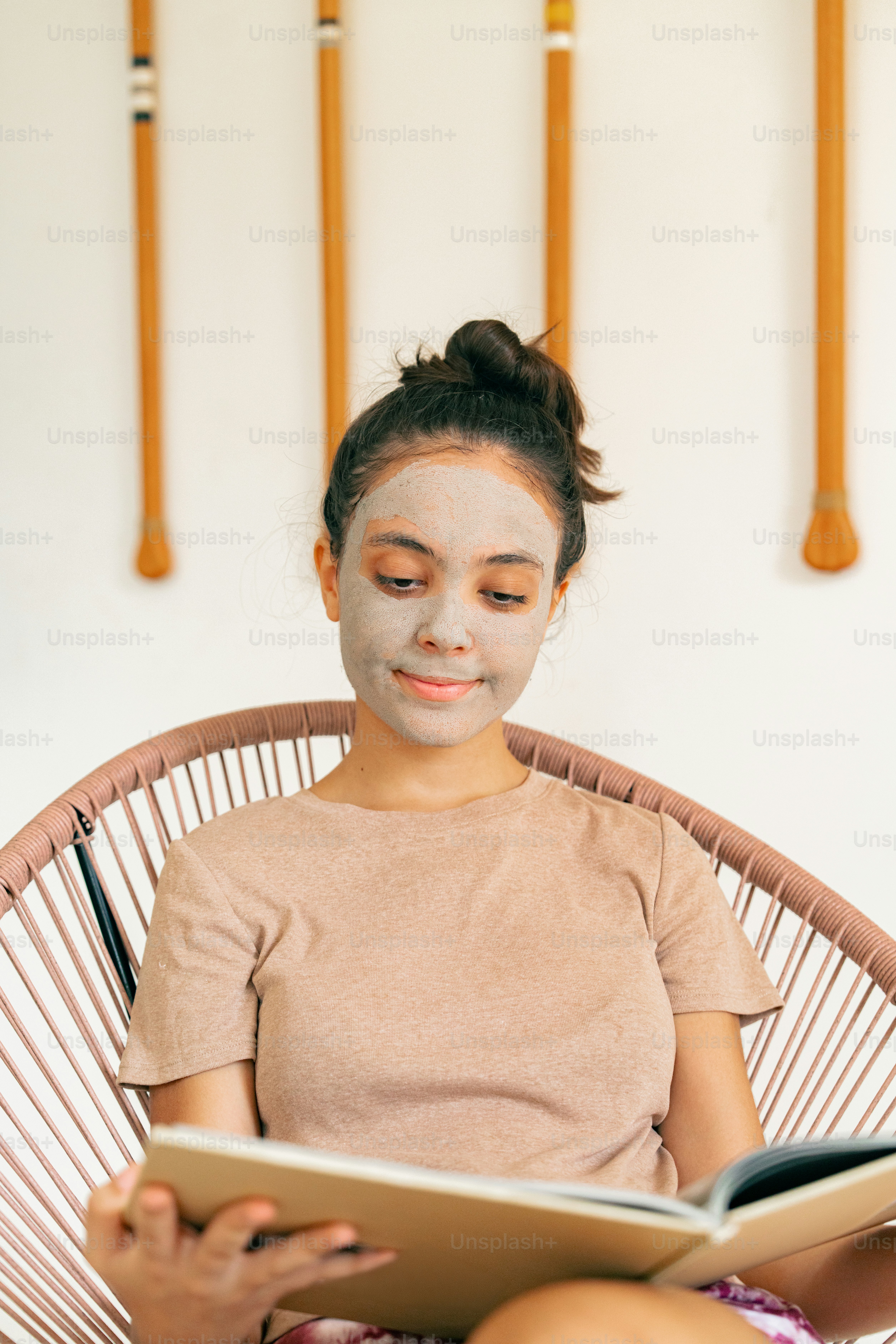 a woman sitting in a chair with a face mask on