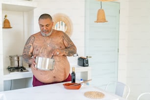 a man with a large belly holding a pot