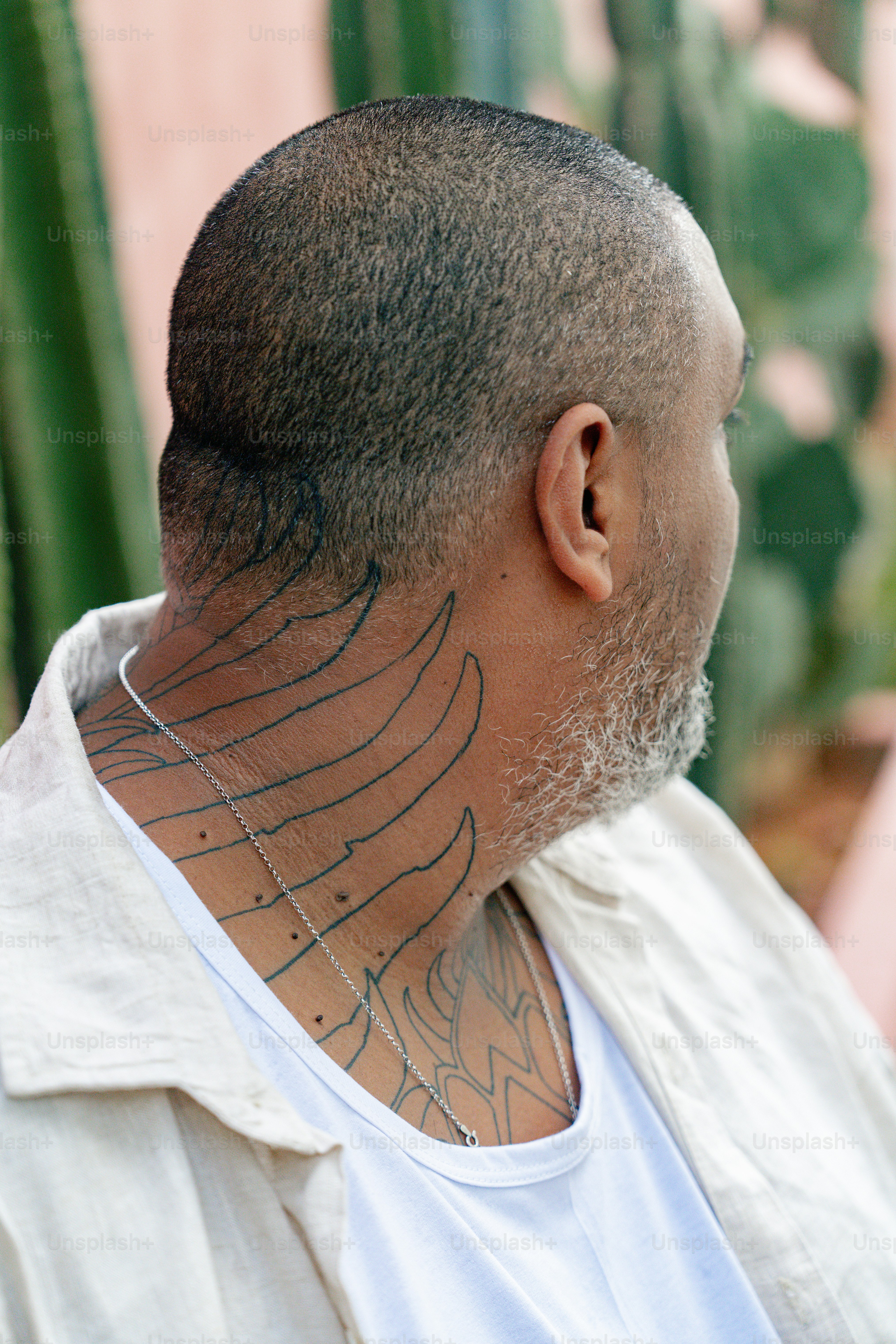 a man with a tattoo on his neck