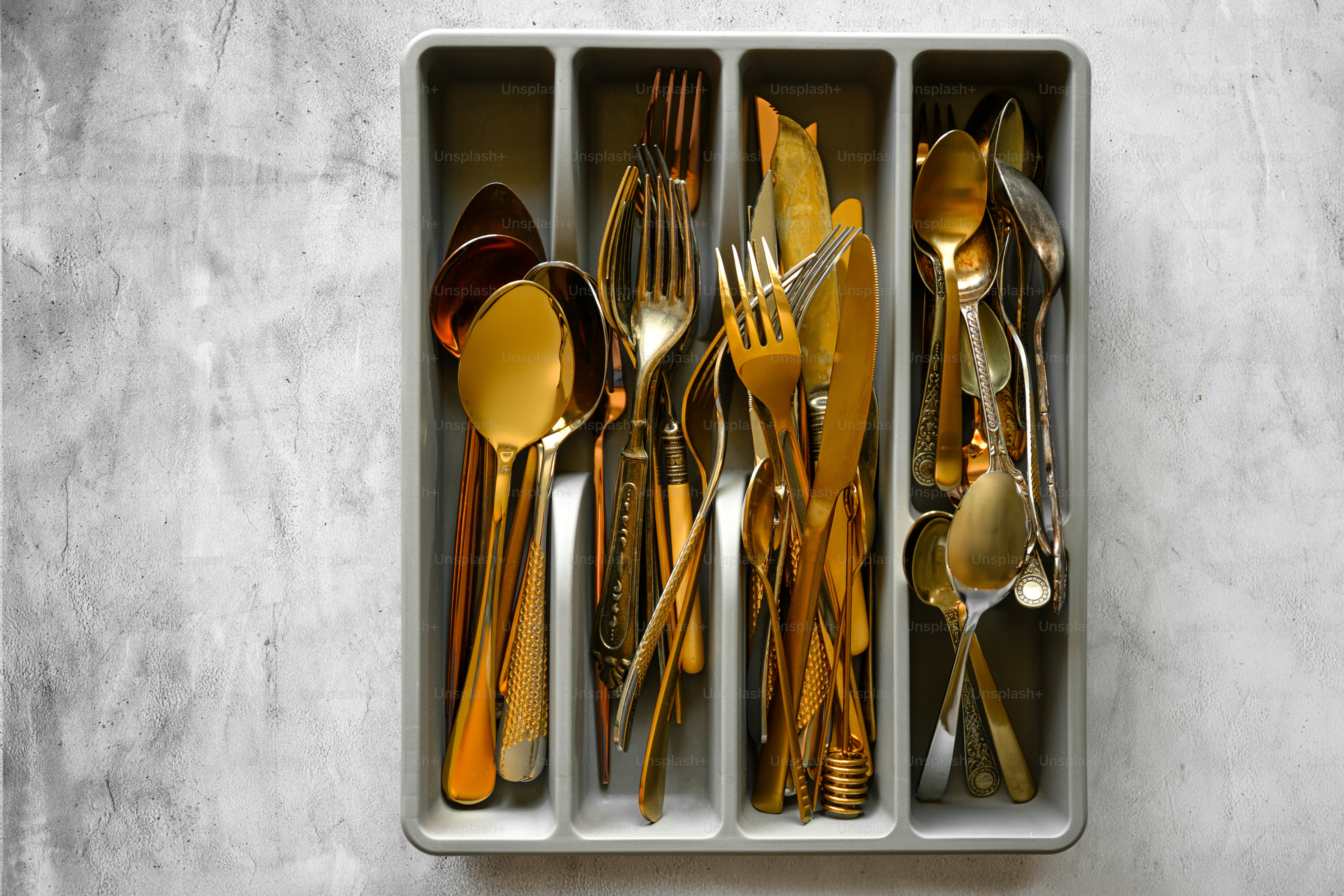 une boîte remplie de beaucoup d’argenterie sur une table