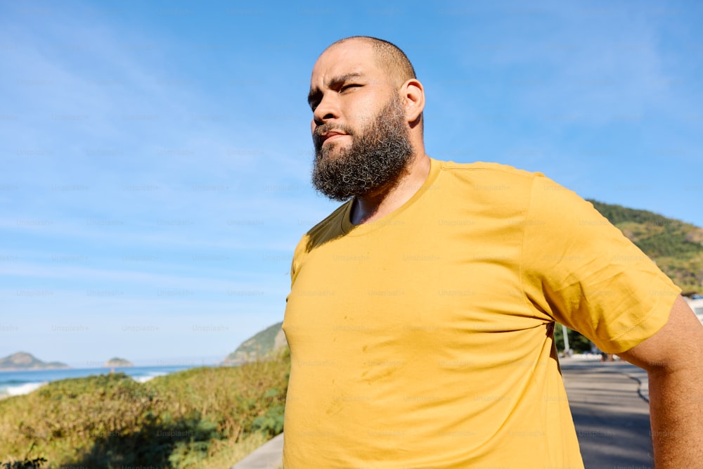 a man with a beard standing on the side of a road