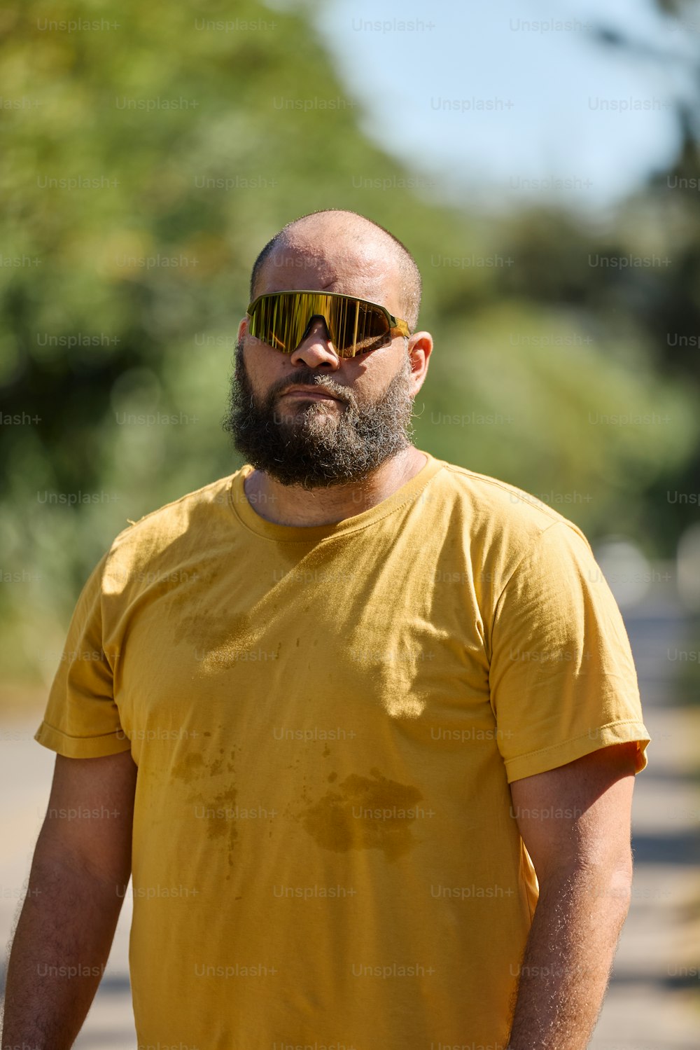 a man in a yellow shirt and sunglasses