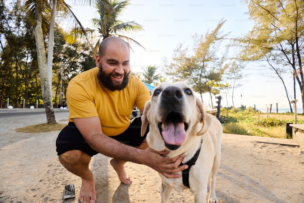 a man petting a dog on the beach