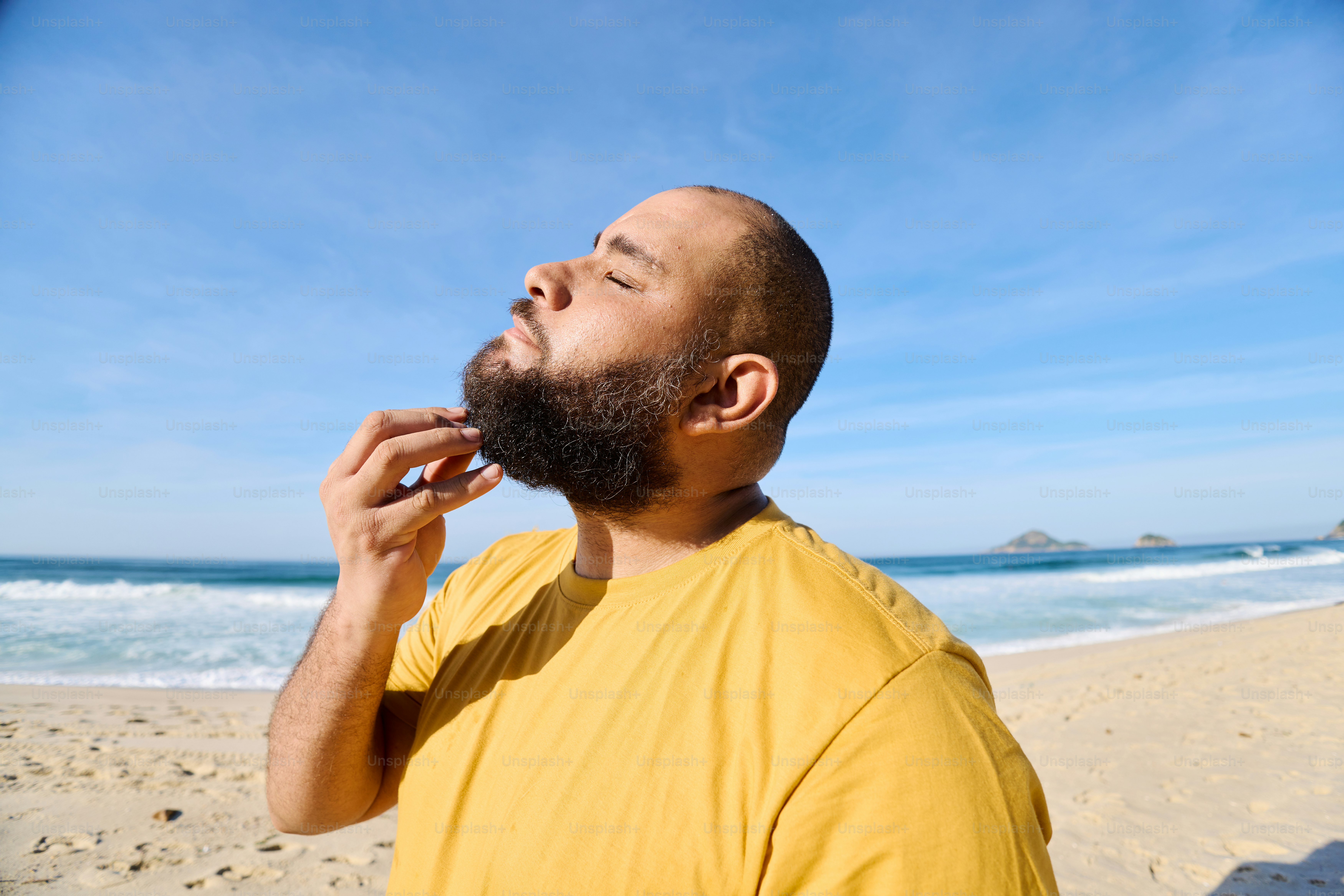 a man with a beard on the beach