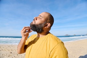 a man with a beard on the beach