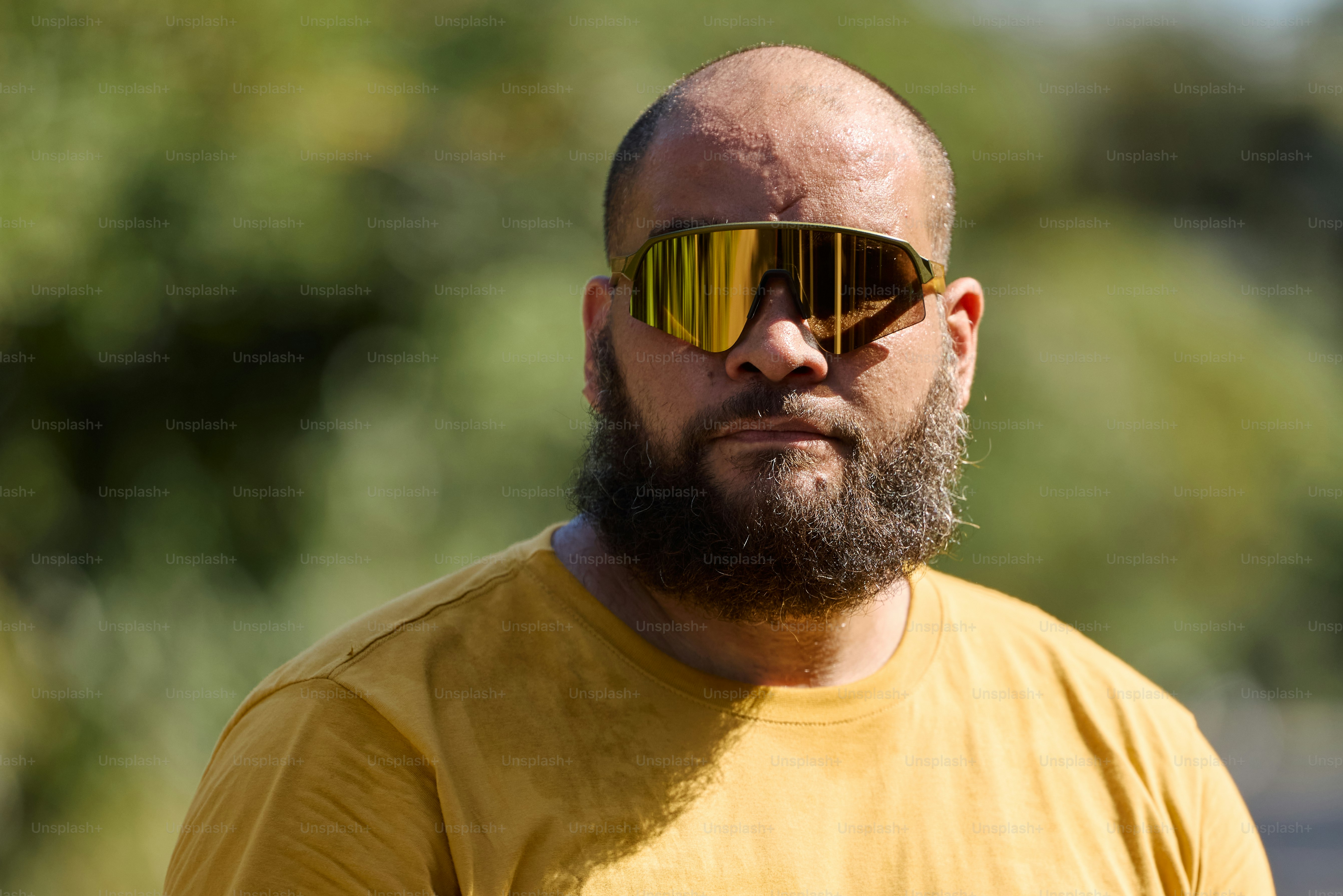 a man with a beard and yellow sunglasses