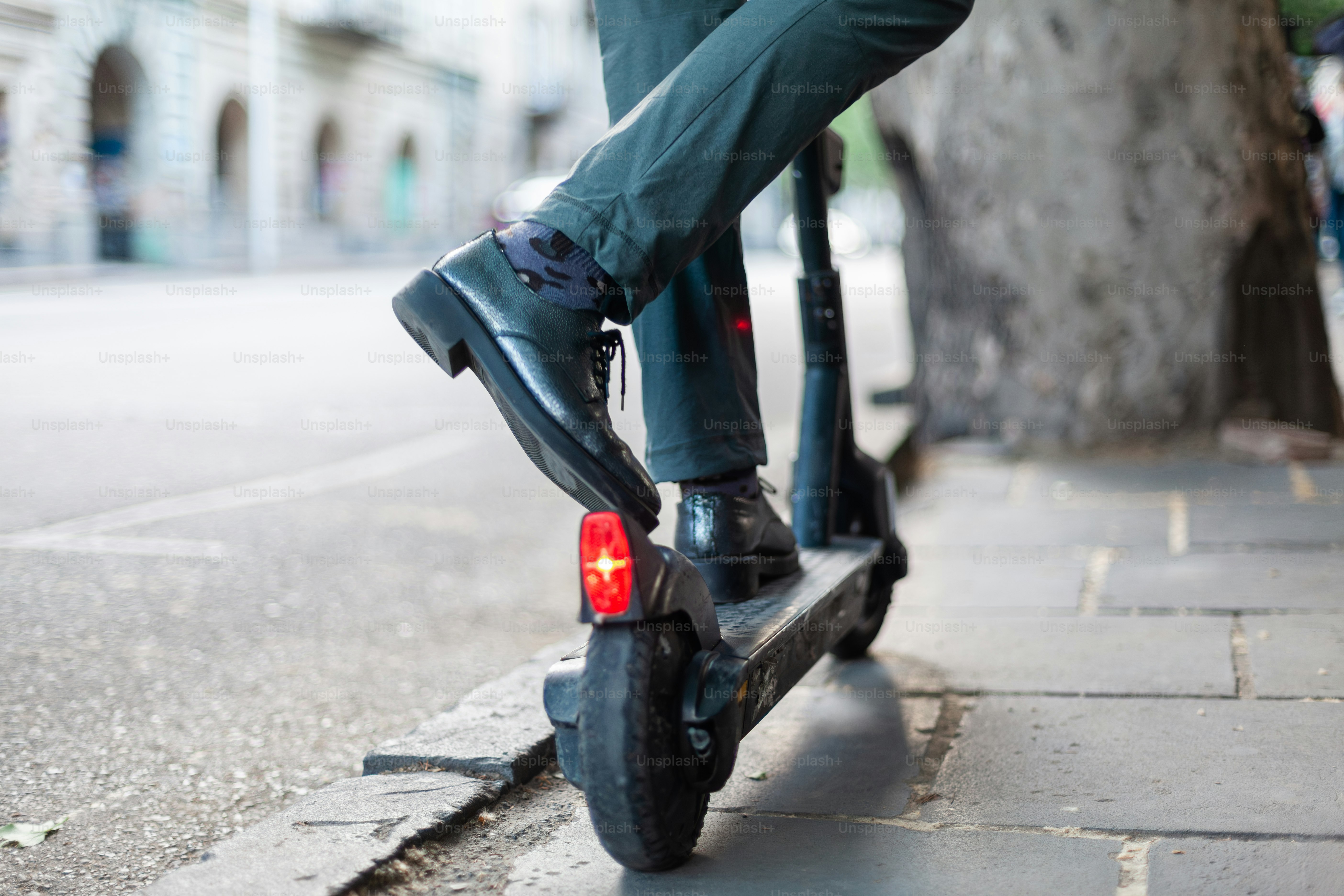 a person riding a scooter on a city street