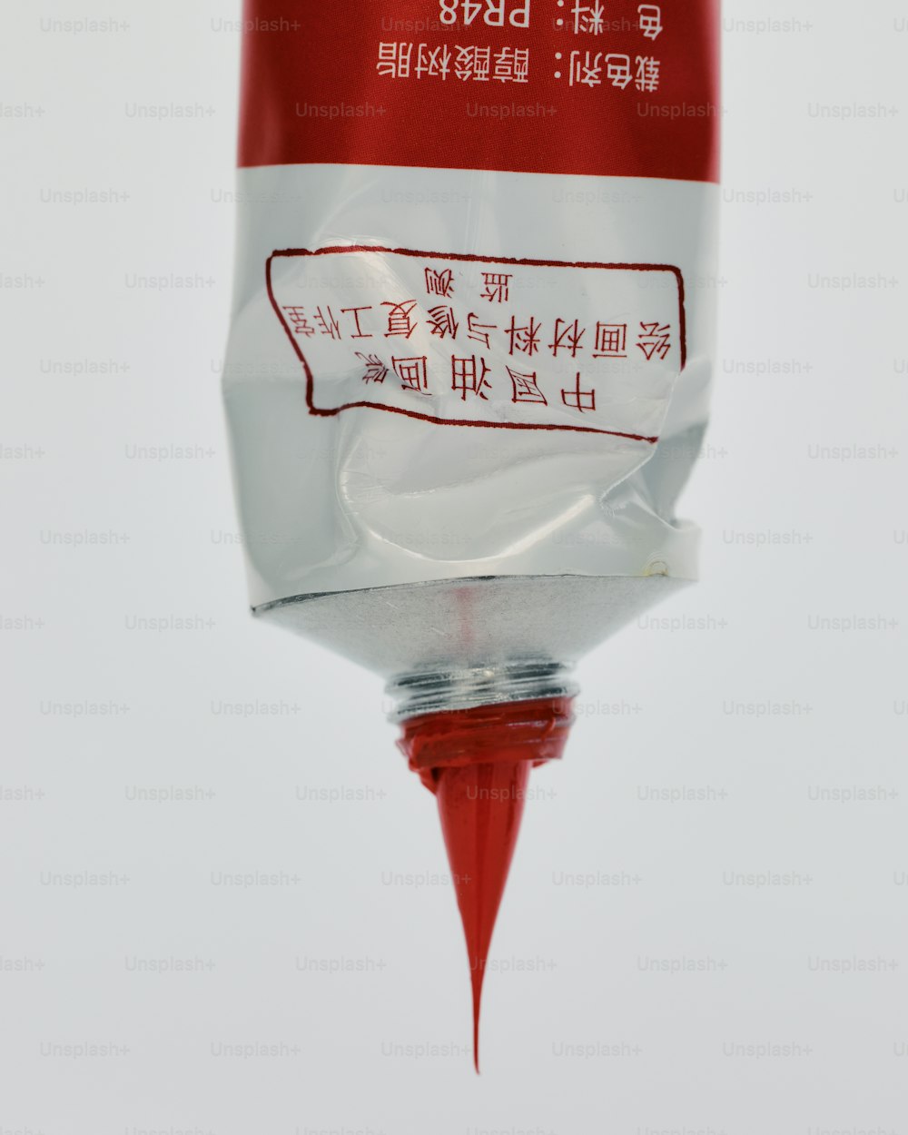 a close up of a red and white object with chinese writing on it