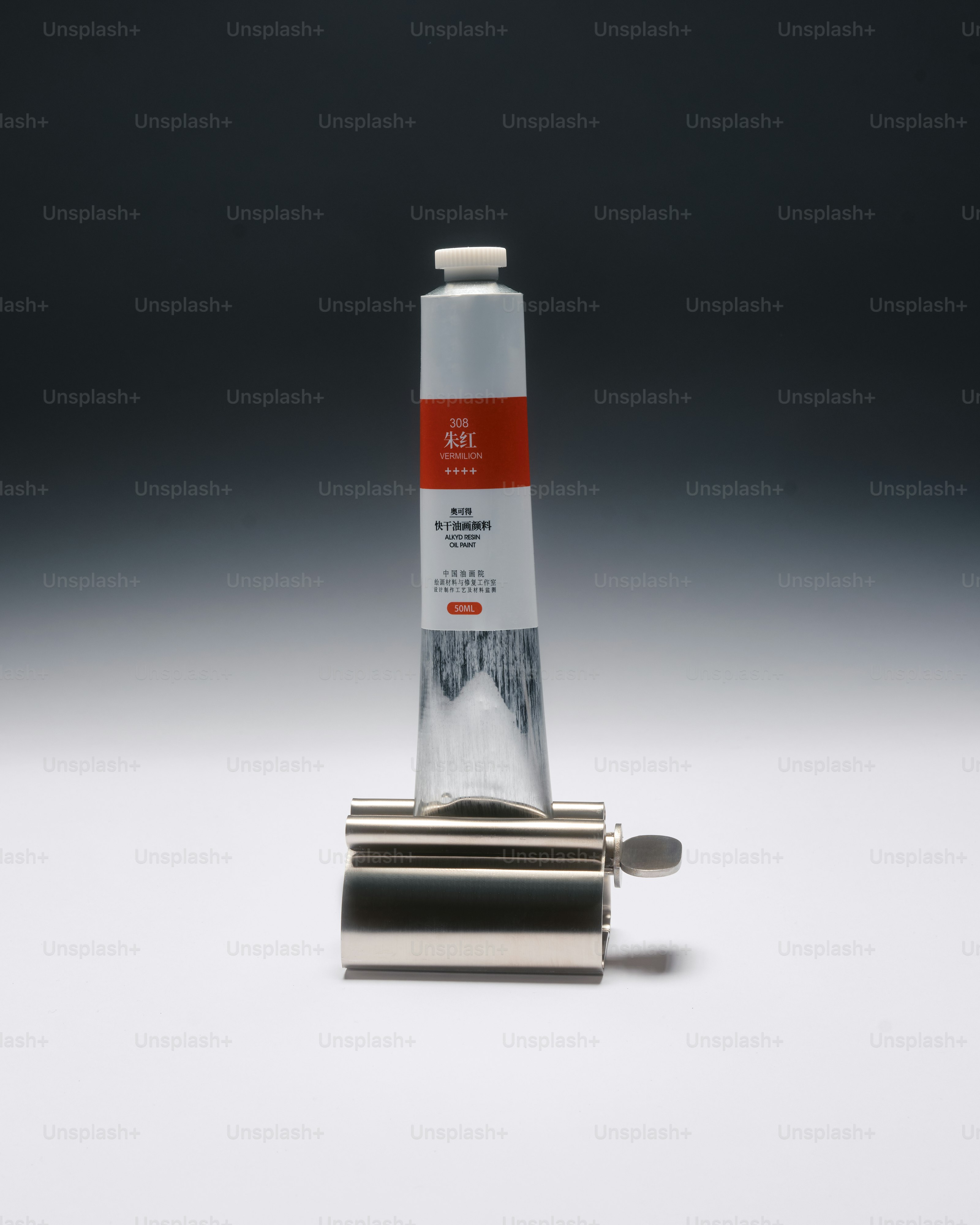 a tube of paint in a paint tube squeezer