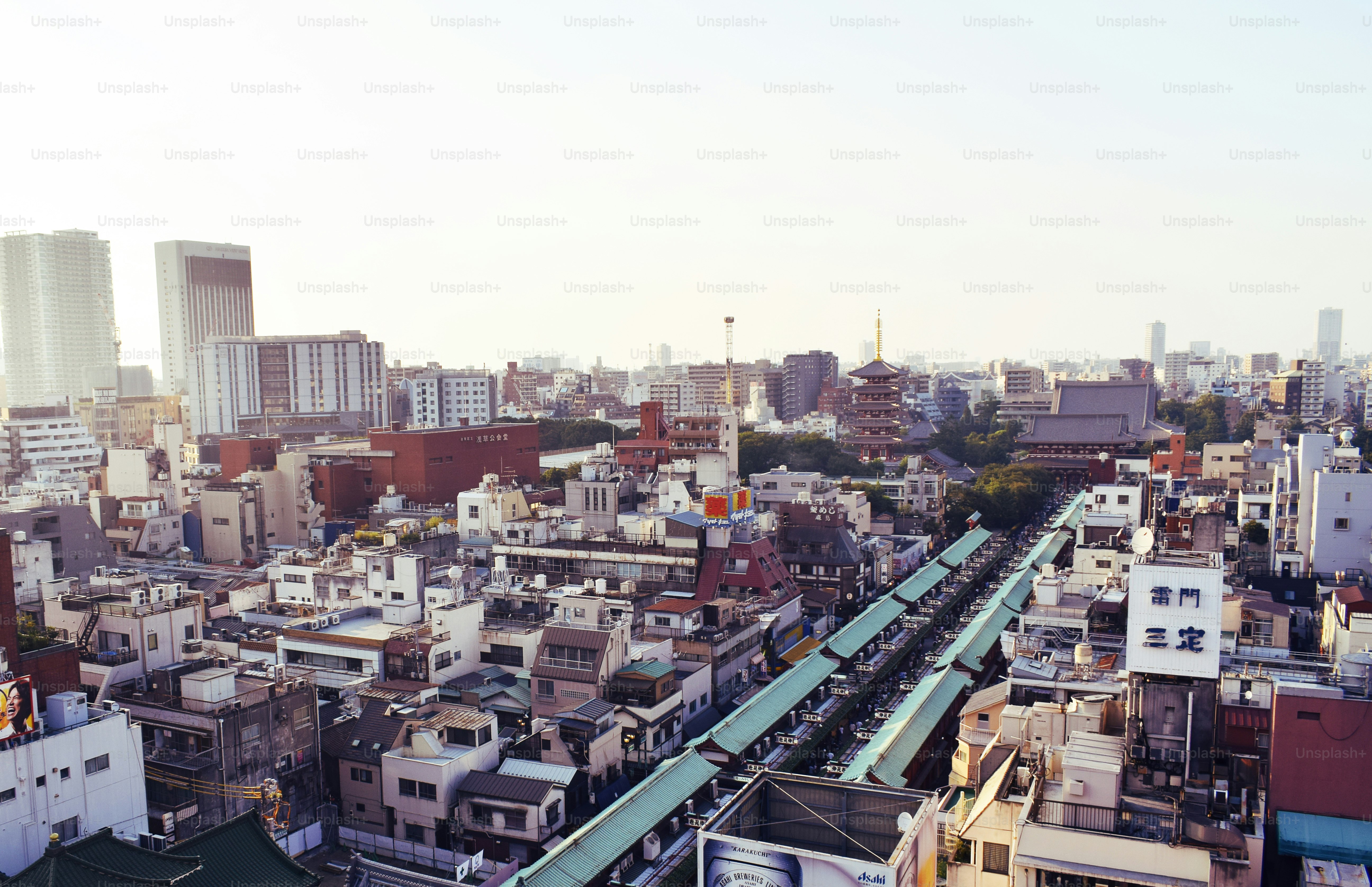 a train traveling through a city next to tall buildings
