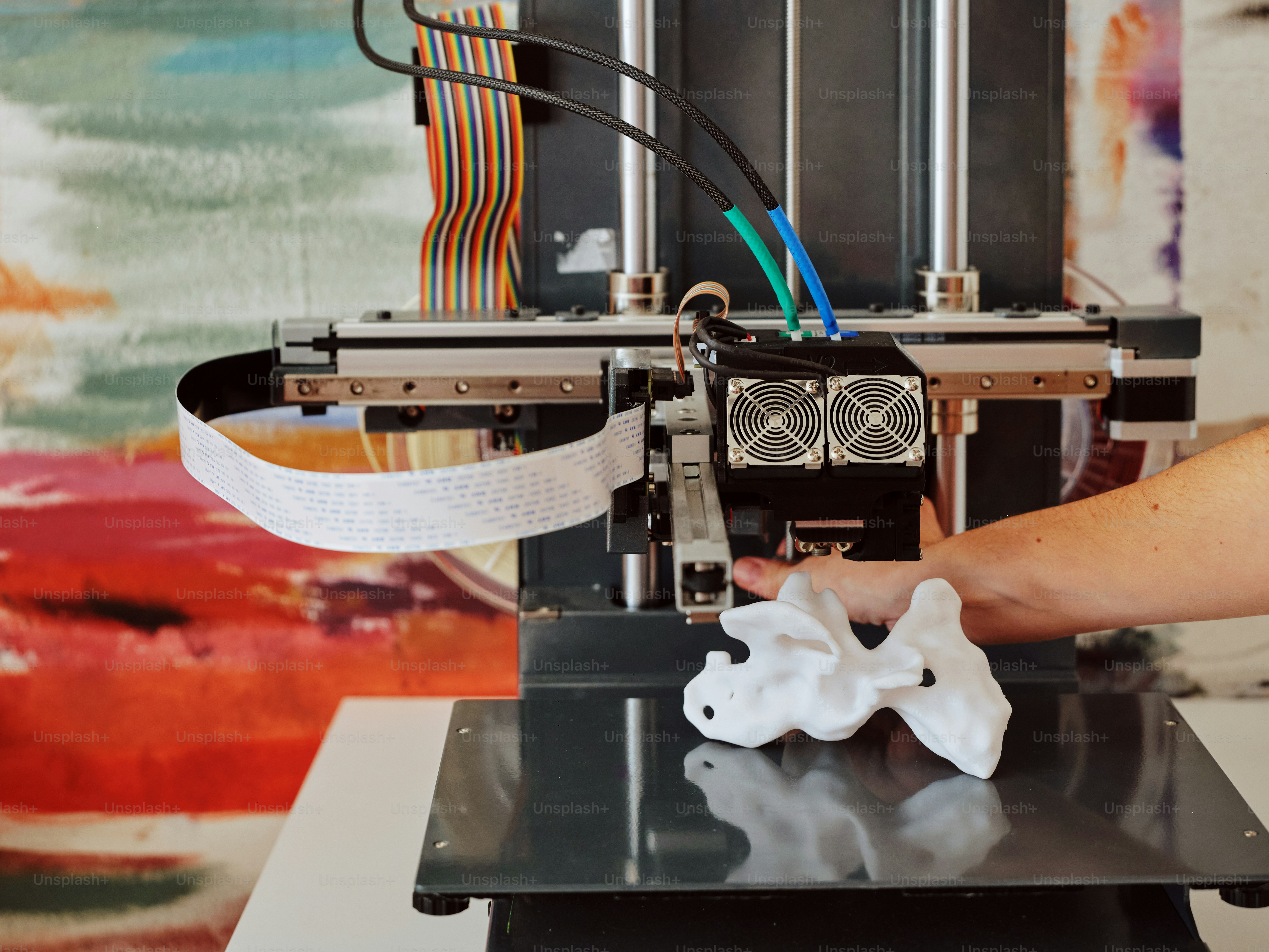 a person is working on a 3d printer