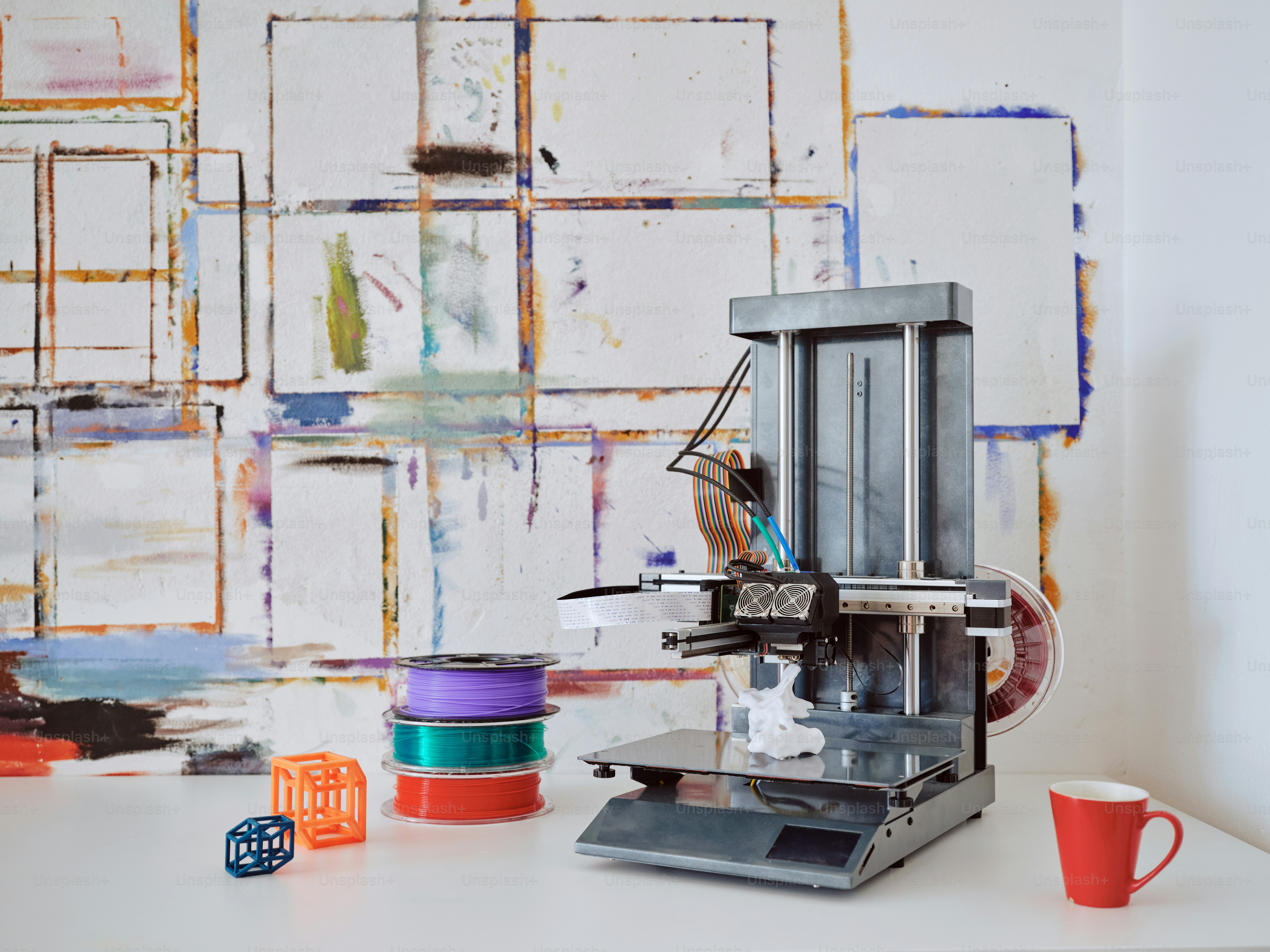 a machine sitting on top of a table next to a cup