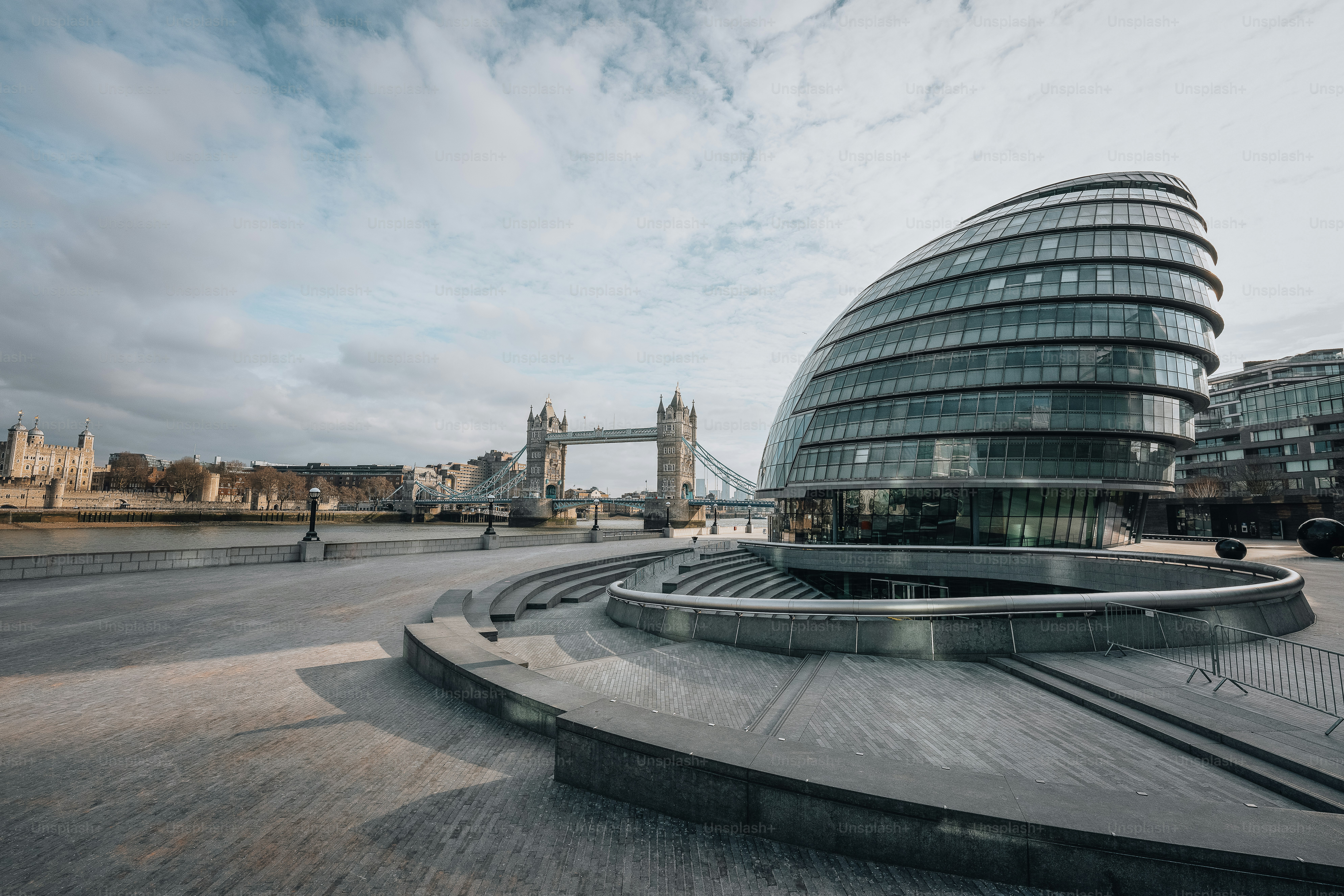 a large building with a curved roof next to a body of water