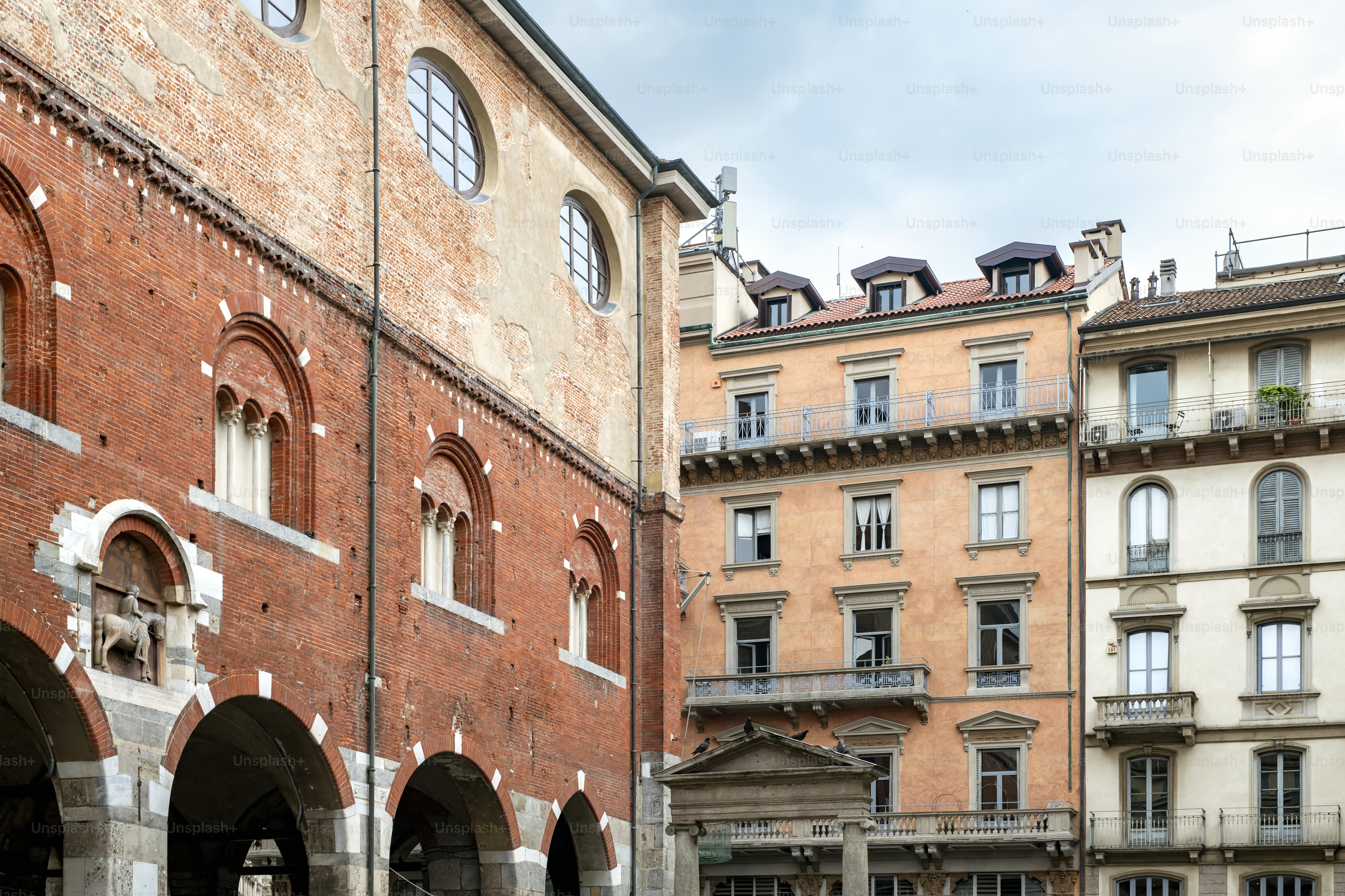 a group of people walking down a street next to tall buildings