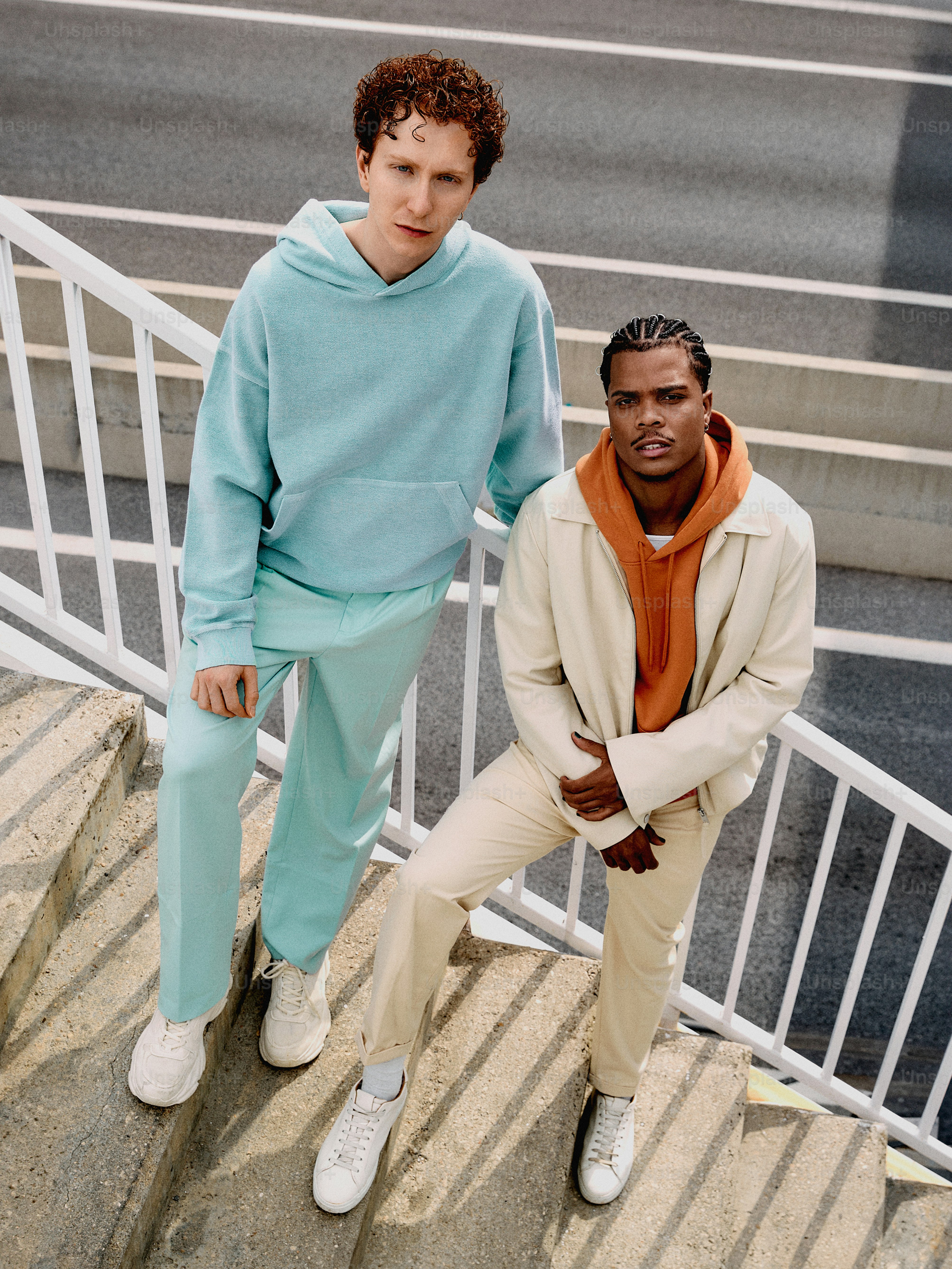 two men standing on a set of stairs next to each other