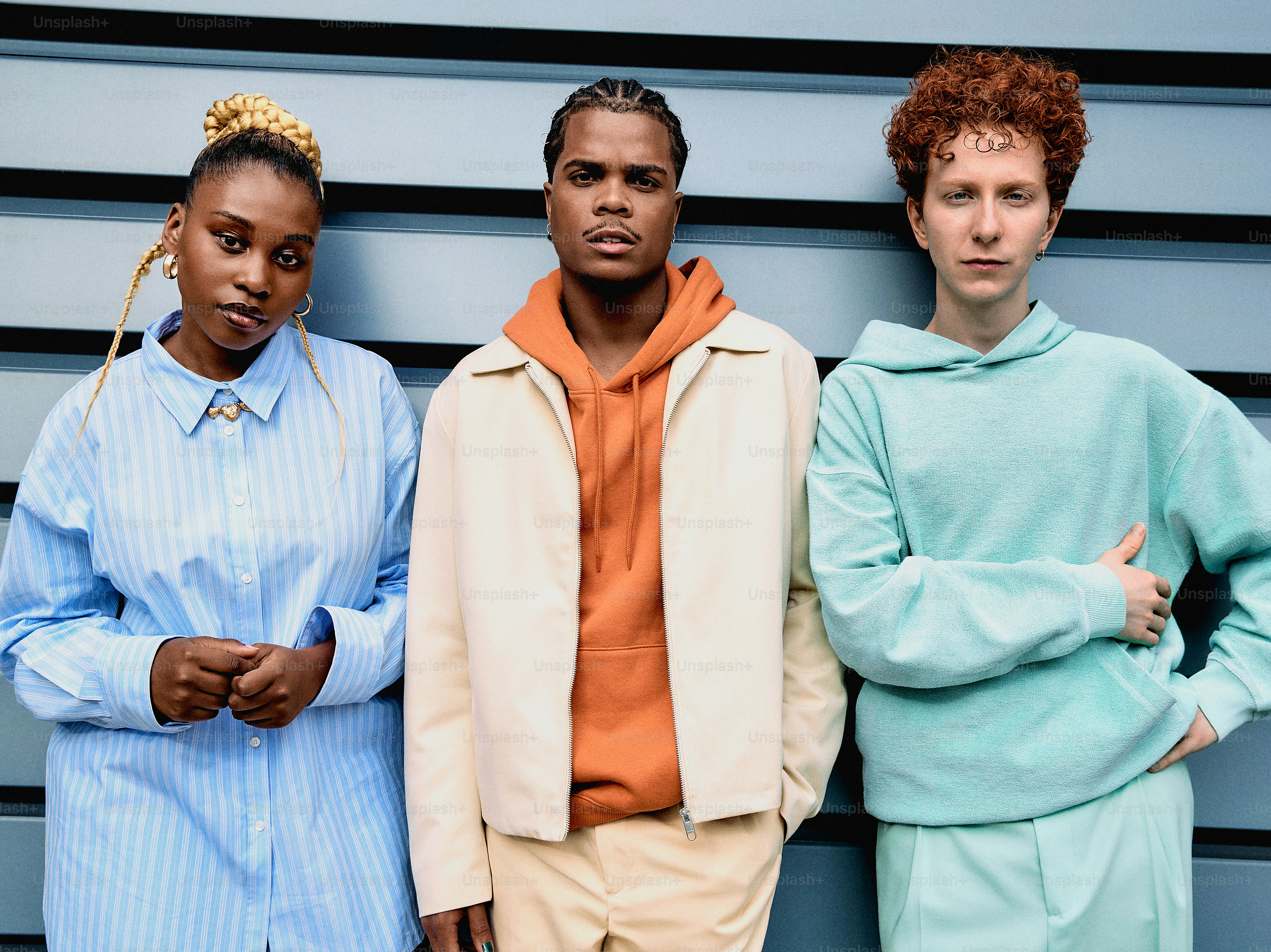 a group of three people standing next to each other